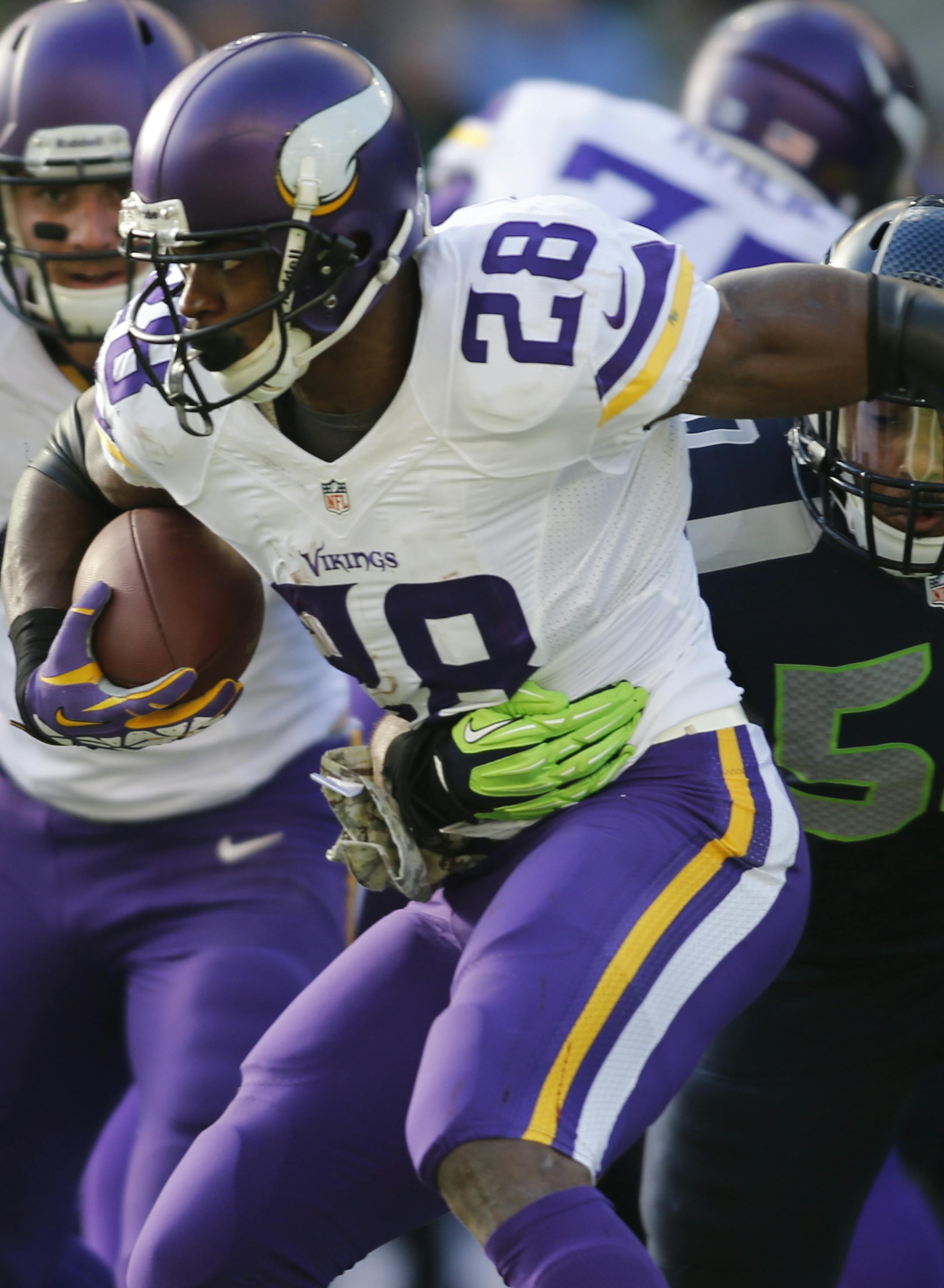 Minnesota Vikings' Adrian Peterson carries the ball with Seattle Seahawks' K.J. Wright hitting him in the first half of an NFL football game, Sunday, Nov. 17, 2013, in Seattle. (AP Photo/John Froschauer) ORG XMIT: NYOTK
