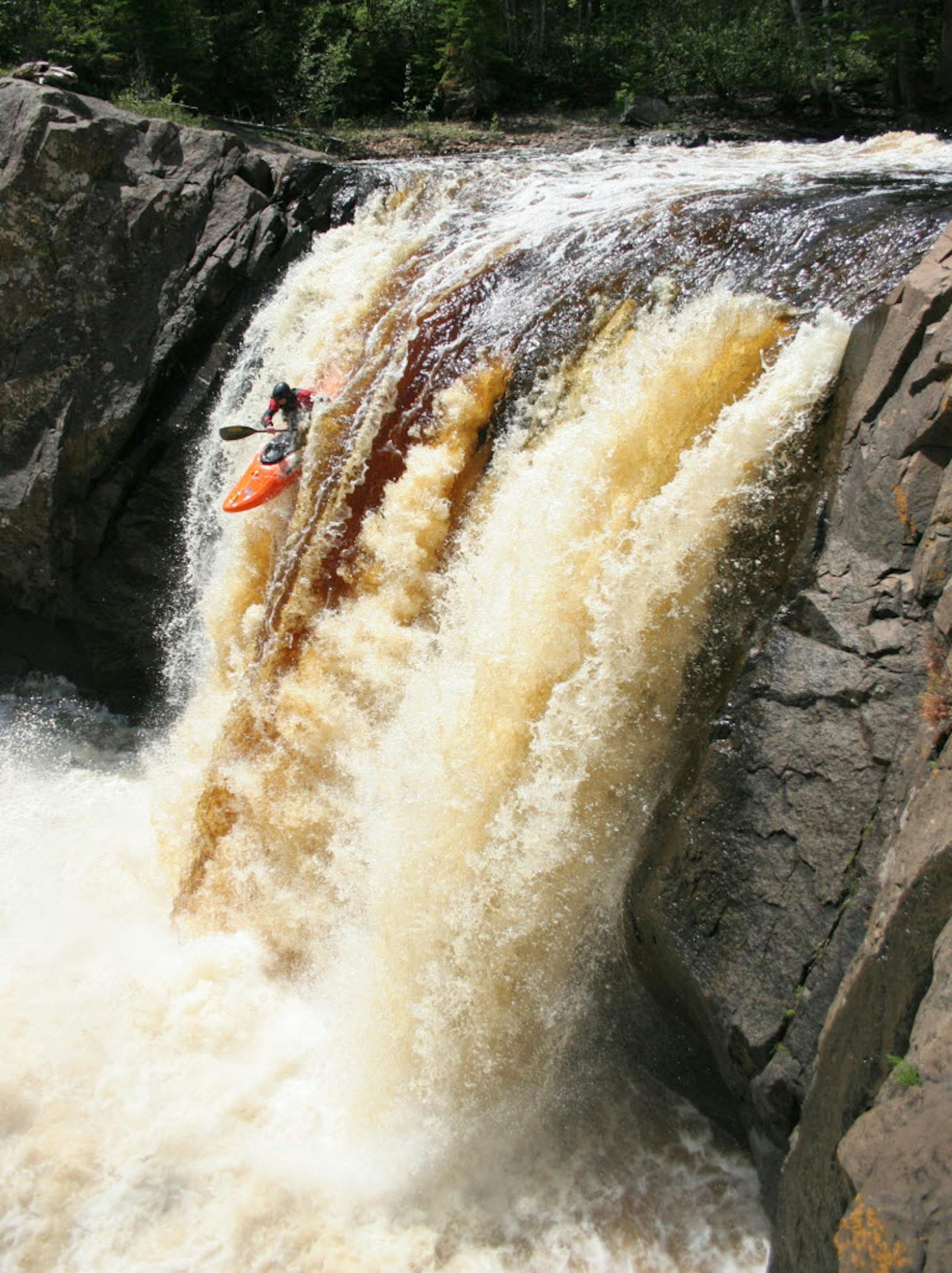 Joerg Steinbach, of Mounds View, paddles hard off the lip of Illgen Falls, a three-story drop on the Baptism River.