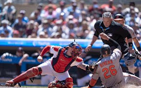 Twins catcher Christian Vázquez tagged out Emmanuel Rivera in the sixth inning Thursday at Target Field. Umpire Manny Gonzalez had a good view.