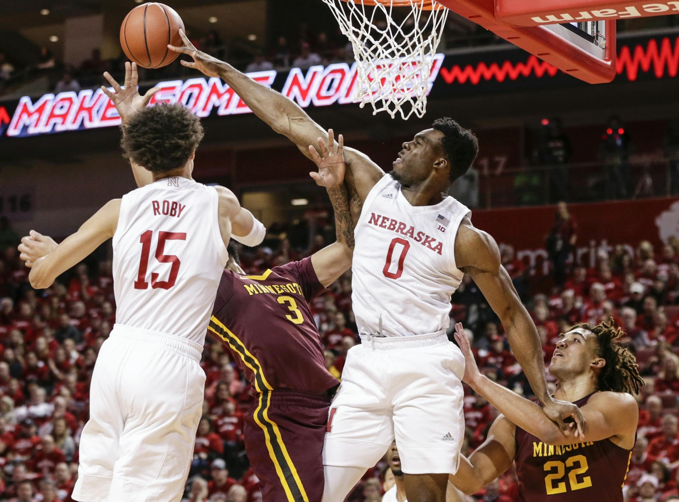 Nebraska's Duby Okeke (0) blocks a shot by Minnesota's Jordan Murphy (3), with Nebraska's Isaiah Roby (15) and Minnesota's Reggie Lynch (22) watching, during the first half of an NCAA college basketball game in Lincoln, Neb., Tuesday, Dec. 5, 2017.