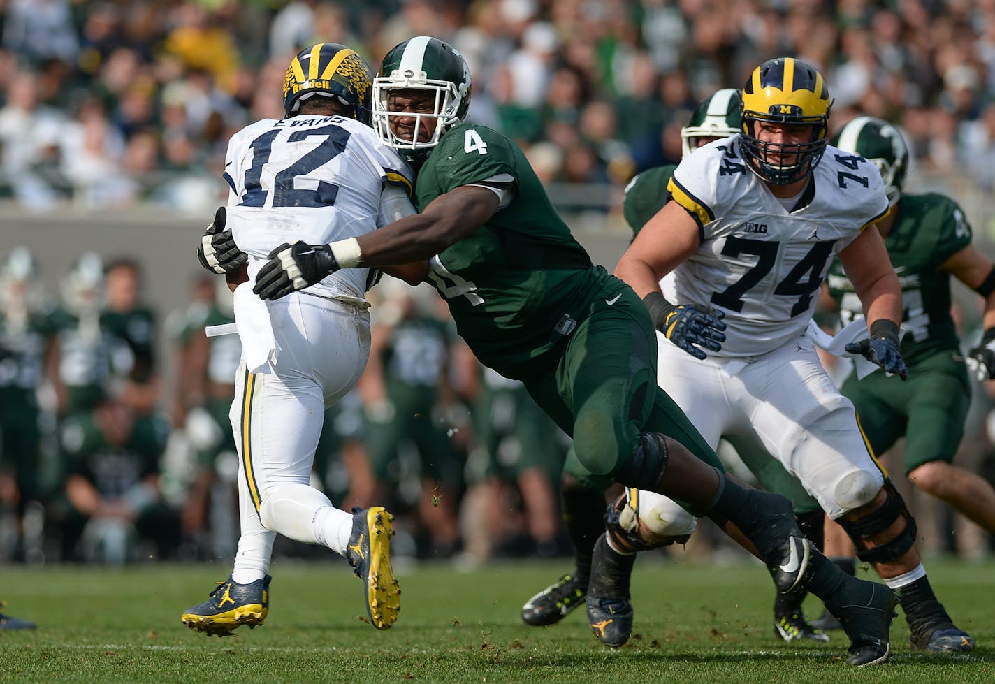 EAST LANSING, MI - OCTOBER 29: Spartans defensive tackle Malik McDowell (4) tackles Wolverines running back Chris Evans (12) behind the line of scrimmage during a Big Ten Conference NCAA football game between Michigan State and Michigan on October 29, 2016, at Spartan Stadium in East Lansing, MI. Michigan defeated Michigan State 32-23. (Photo by Adam Ruff/Icon Sportswire) (Icon Sportswire via AP Images) ORG XMIT: 265151