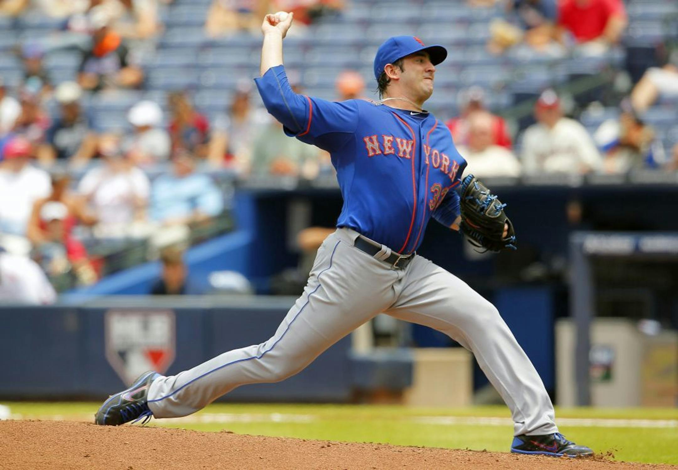 Matt Harvey throws in the fourth inning against the Atlanta Braves, Tuesday, June 18, 2013, in Atlanta.
