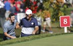 USA golfer, Patrick Reed and European, Rory McIlroy, show respect to each other as they approach to the 8th tee box during the Sunday morning match pl