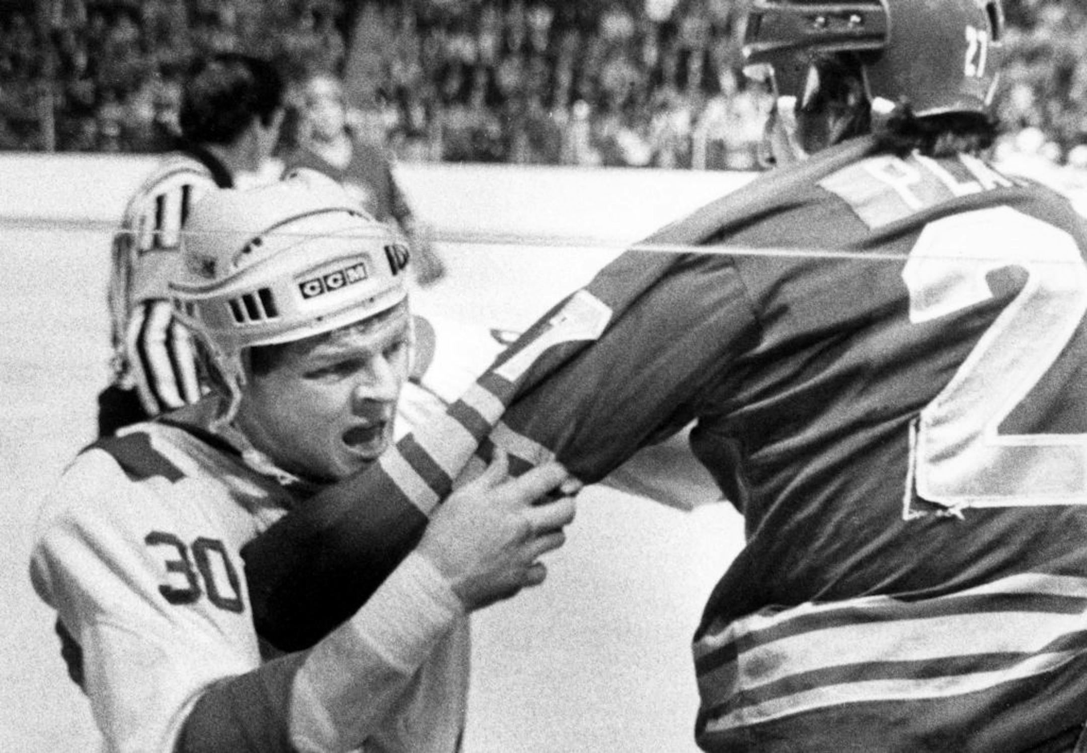 FILE - In this Apri 5, 1983, file photo, Montreal Canadiens' Chris Nilan grapples with along the boards with Buffalo Sabres' Larry Playfair during the first period of a NHL hockey game in Montreal. Nilan battled herioin and alcohol addiction long after his career as one of the NHL's top brawlers. His life is documented in the documentary "The Last Gladiators."
