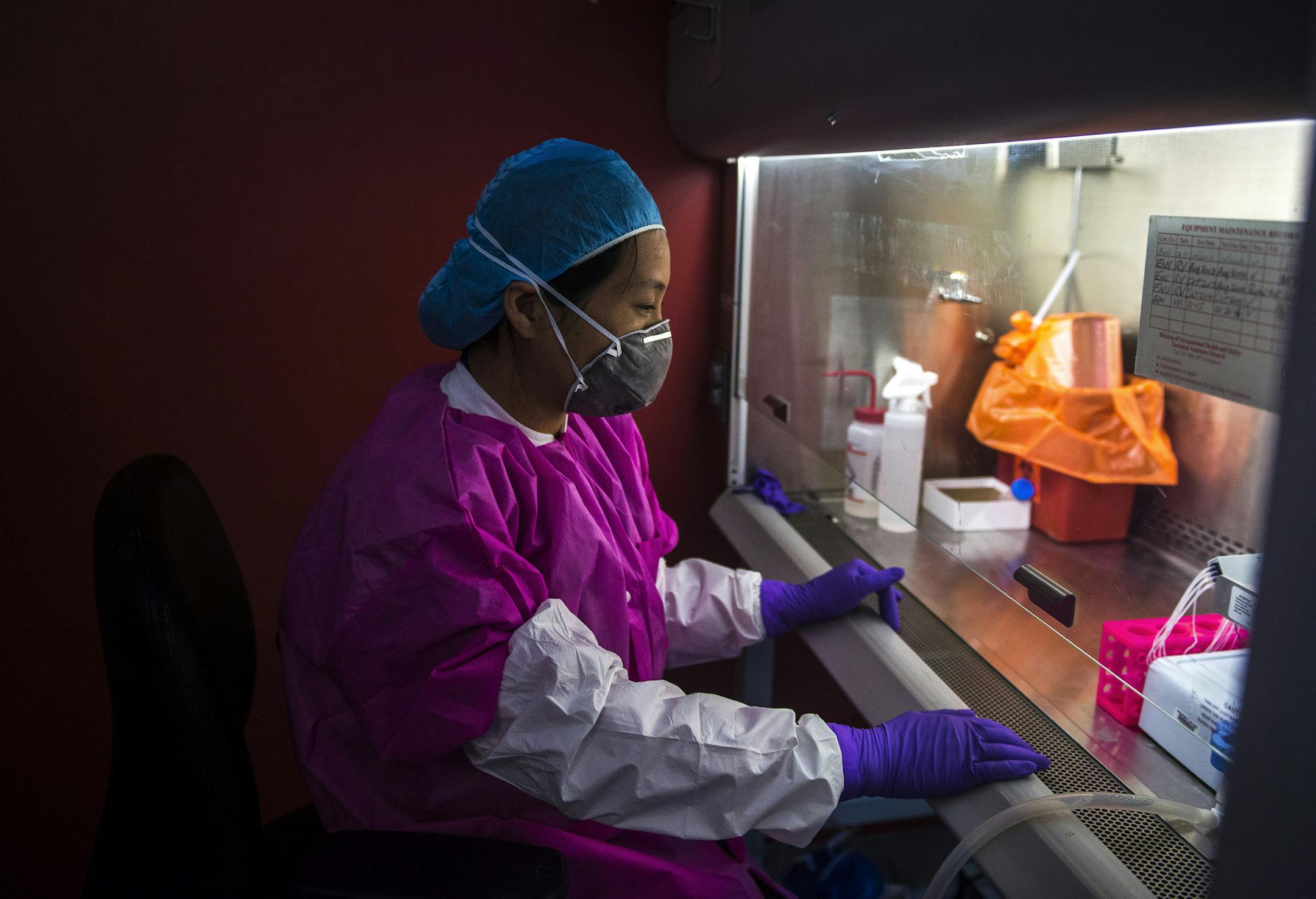 FILE -- A scientist works with the Zika virus at a lab run by the National Institutes of Health, which faces a proposed cut of 18 percent, in Bethesda, Md., April 6, 2016. Scientists expressed alarm at the depth of proposed cuts to climate change, medical and energy programs, saying they threaten the nation’s research infrastructure.