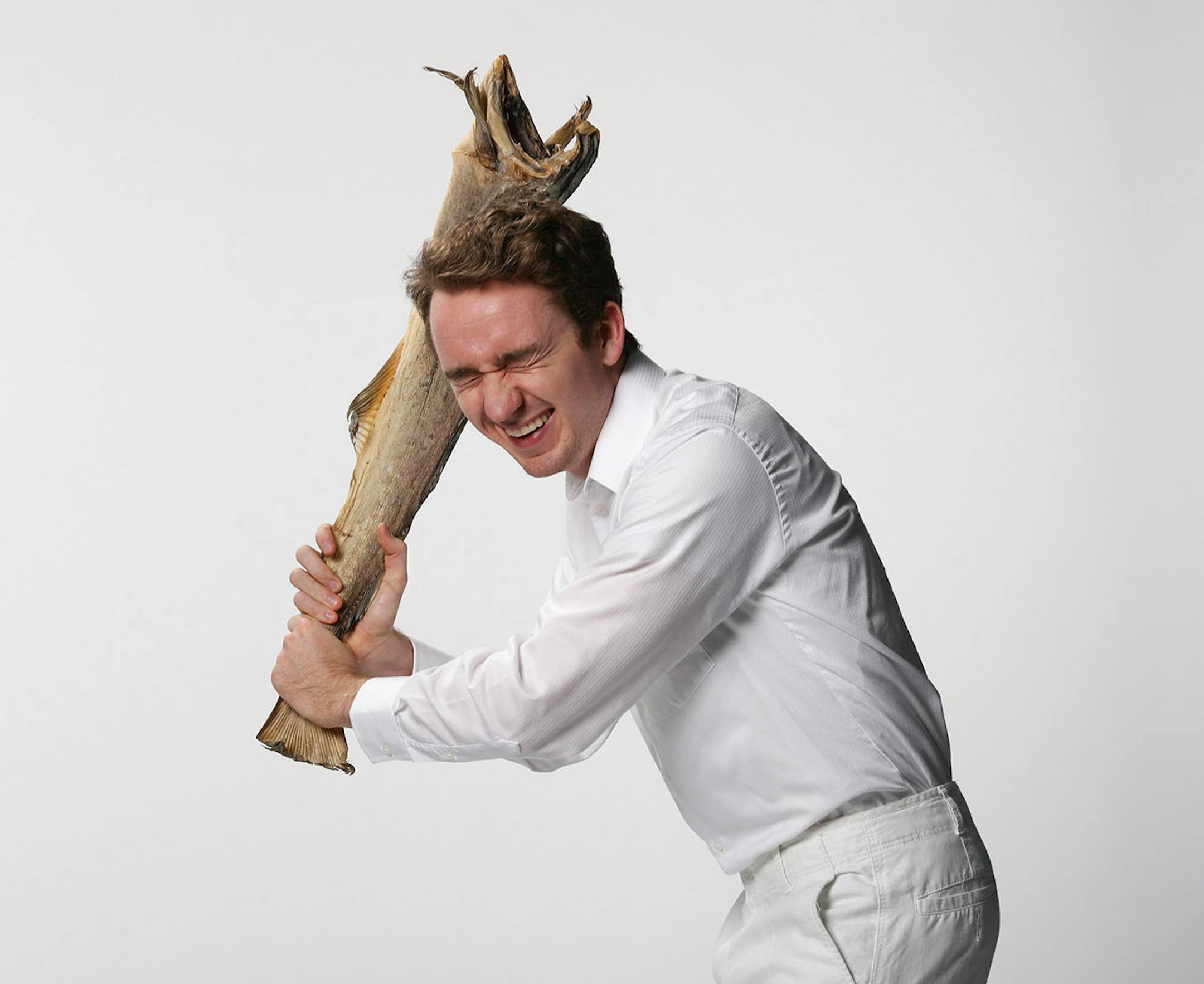 Nels Thompson with a dried cod, the basis of many a Scandinavian holiday meal. ] JEFF WHEELER ï jeff.wheeler@startribune.com Nels Thompson took over planning the traditional Scandinavian holiday meal at his church with the intent of making it appeal to twentysomethings like himself. He was photographed with dried cod in the StarTribune studio on Thursday afternoon, November 3, 2016.