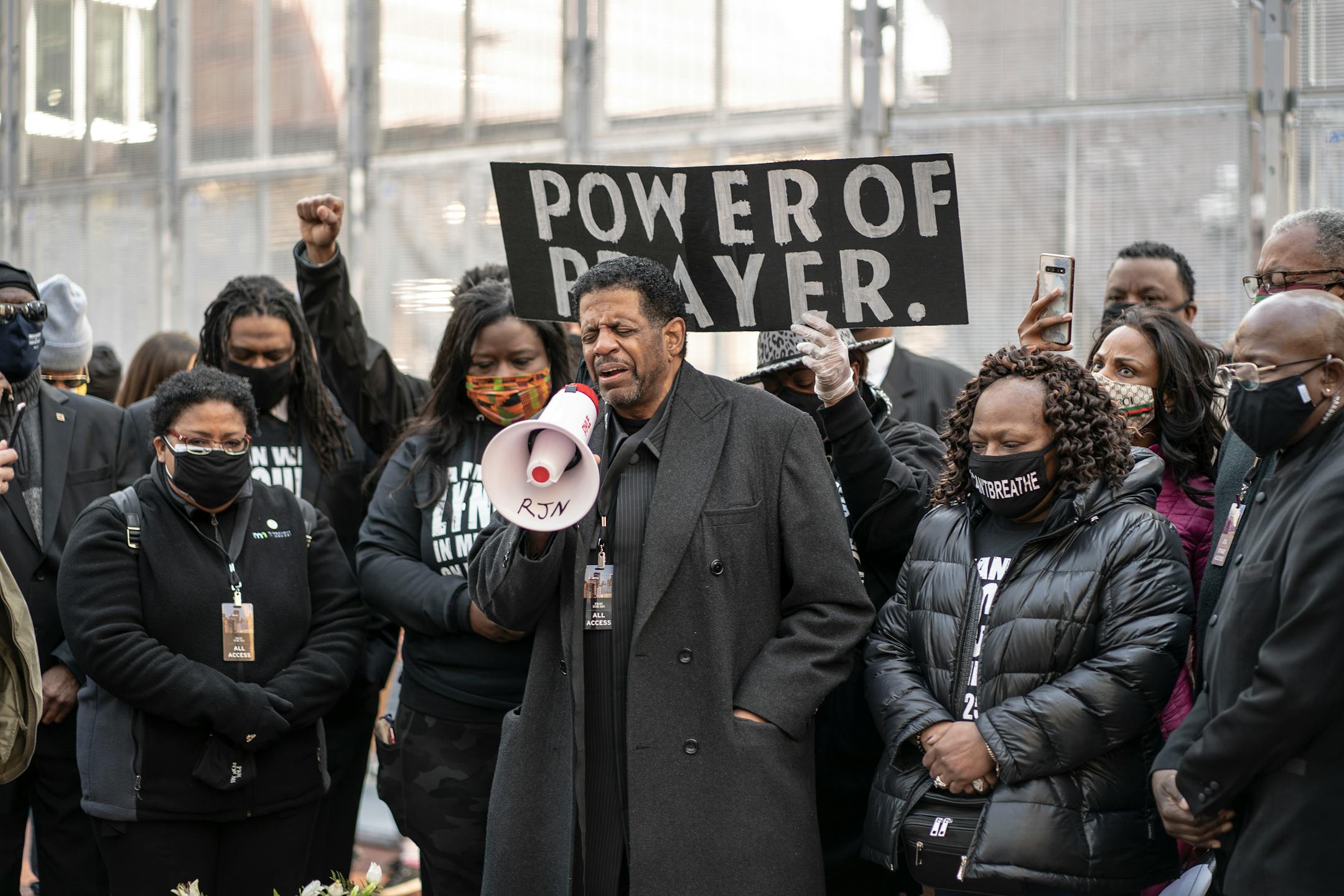 Bishop Richard D. Howell of Shiloh Temple lead a prayer on the plaza of the Hennepin County Government Center, Sunday March 7, 2021 In Minneapolis.