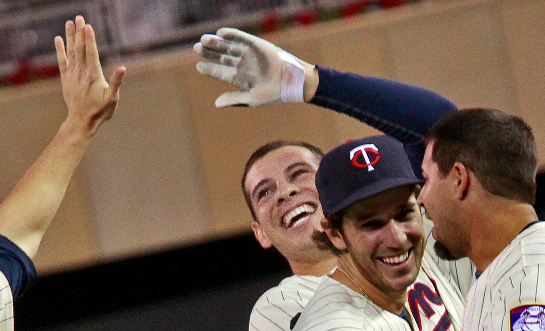 Twin Danny Valencia, center, accepted congratulations from teammates after he knocked in the winning run in the 10th inning to win the game 1-0.