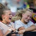 (From left) Jana Impola and Kaitlyn Kangas laugh and scream as they ride Delano's version of the scrambler.