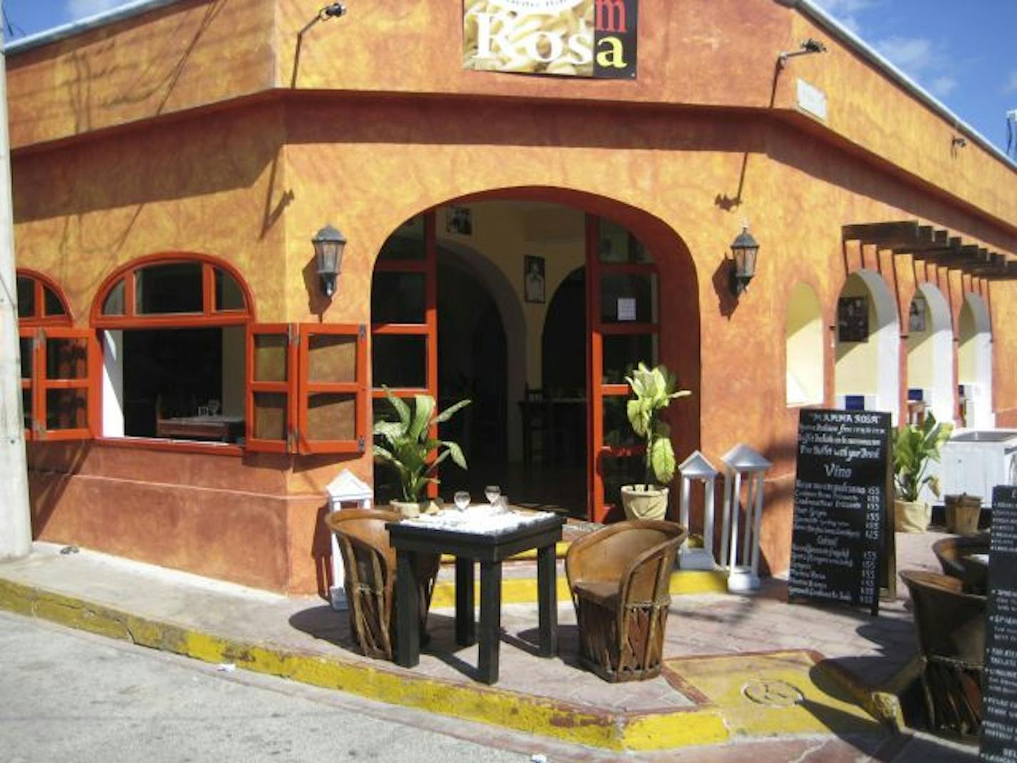 Sun warms a table set street side at a cafe on Isla Mujeres, on Mexico's Riviera Maya.