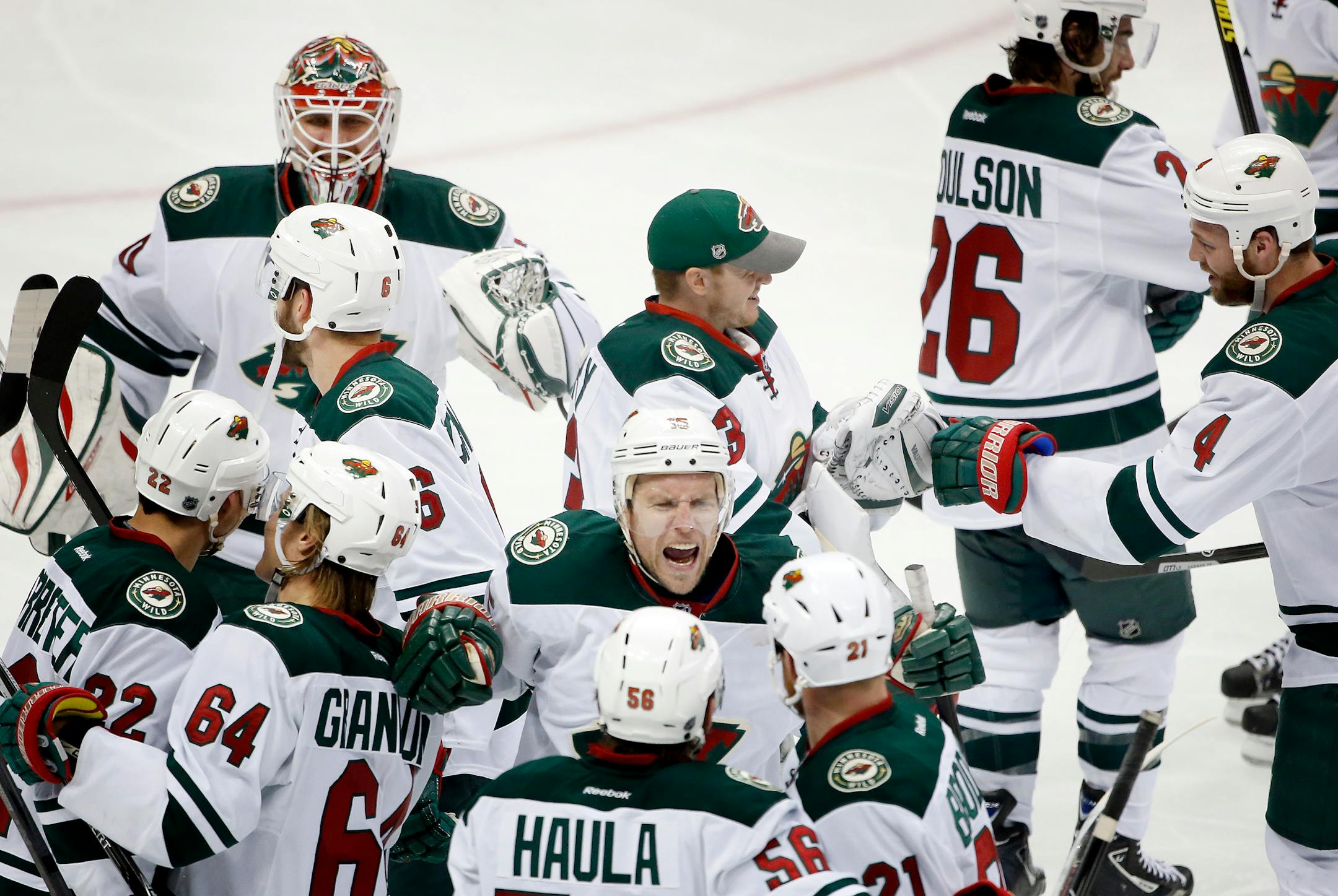 Nino Niederreiter (22) celebrated with teammates after scoring the game winning goal in overtime.