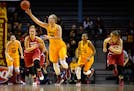 Minnesota Golden Gophers forward Whitney Tinjum (30) passed the ball to a teammate during a fourth quarter breakaway Saturday.