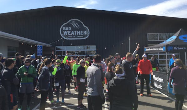 First-time 5K runners raised their hands at the start of the St. Paul Bad Weather Brewing race, one of 31 Minnesota 5Ks in the Brewery Running Series.