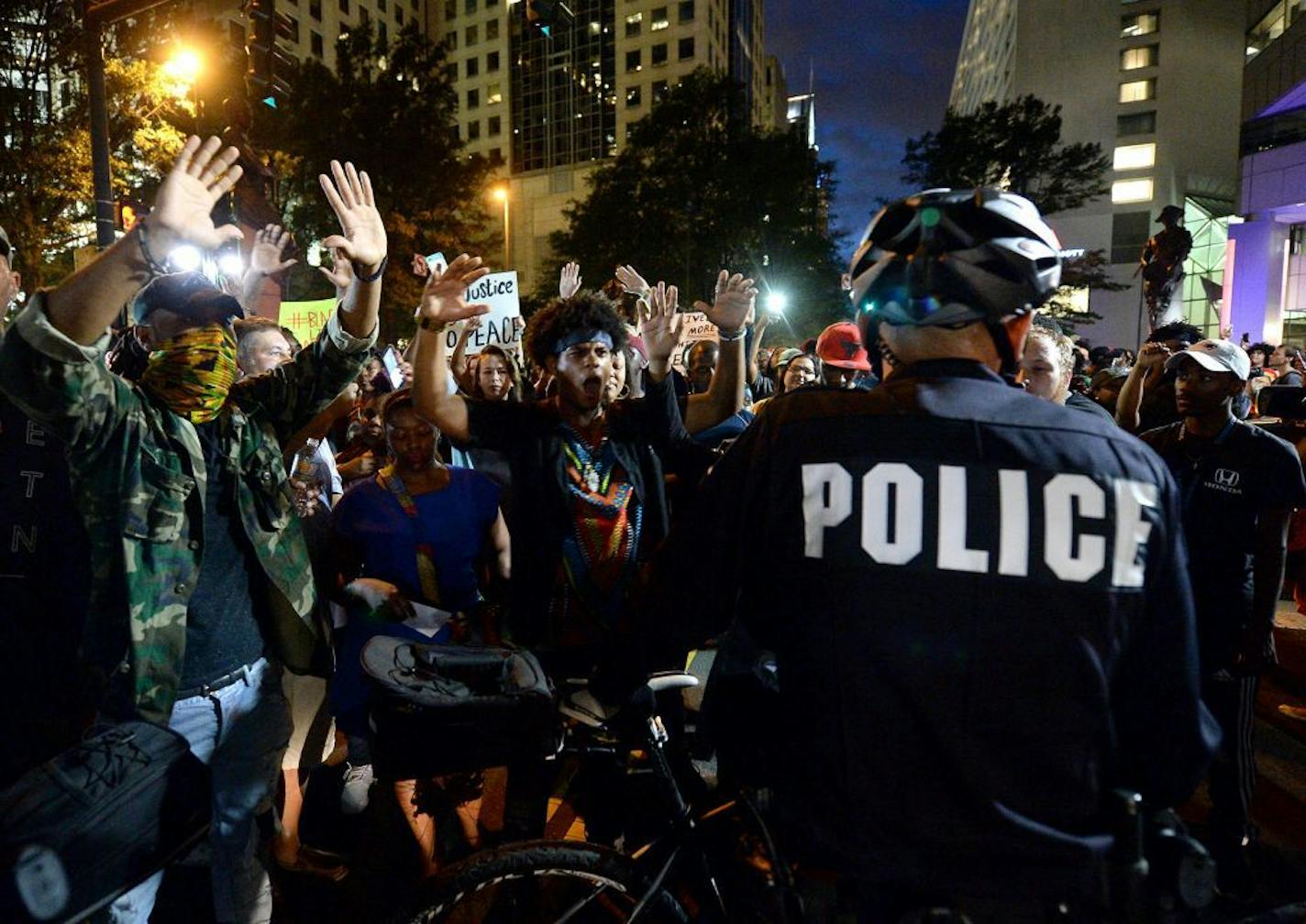 Protestors confront bicycle officers along Trade Street in Charlotte, N.C., on Wednesday, Sept. 21, 2016. The protestors were rallying against the fatal shooting of Keith Lamont Scott by police on Tuesday evening in the University City area.