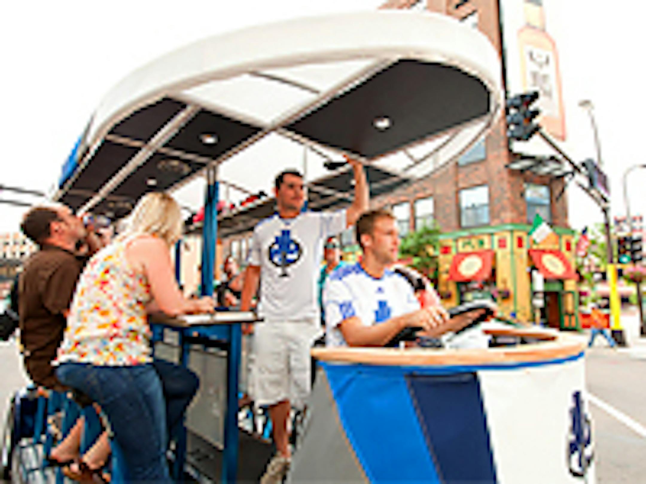 Rhett Reynolds, standing, with a City Cycle party in downtown Minneapolis