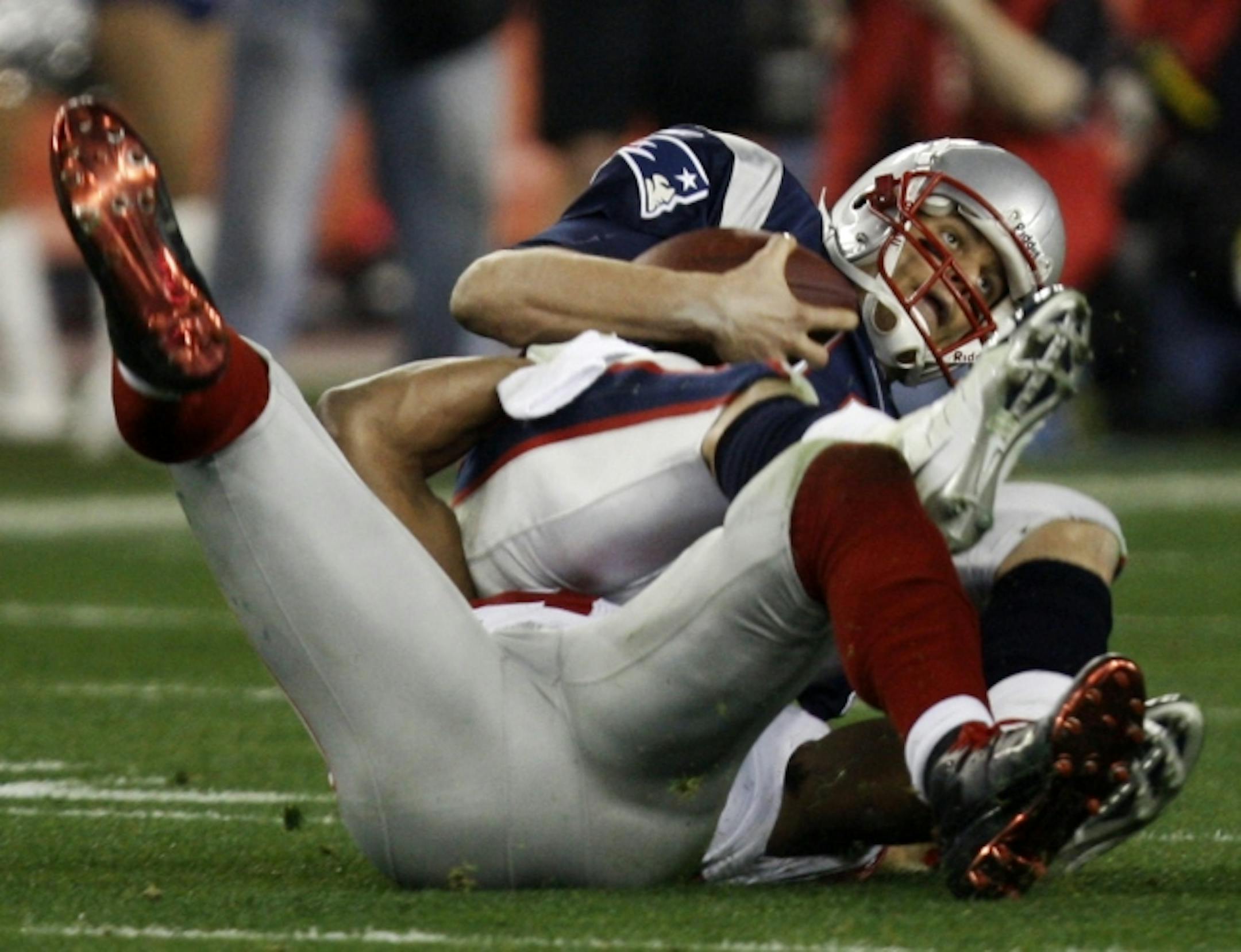 New England Patriots quarterback Tom Brady (12) is sacked by New York Giants defensive end Michael Strahan during the third quarter of the Super Bowl XLII football game at University of Phoenix Stadium on Sunday, Feb. 3, 2008 in Glendale, Ariz. The Giants upset the Patriots, 17-14.