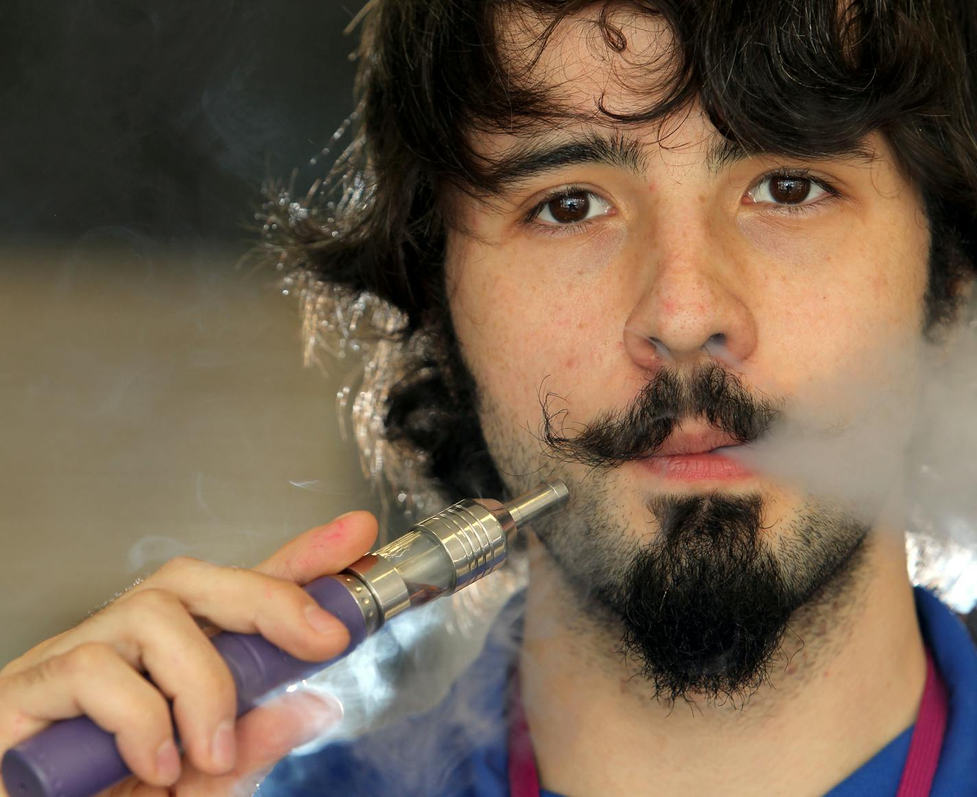 Mike Huber, a sales representative at the E Cig Crib in Coon Rapids, Minn., models an e cigarette on Saturday, June 29, 2013. ] (ANNA REED/STAR TRIBUNE) anna.reed@startribune.com (cq)