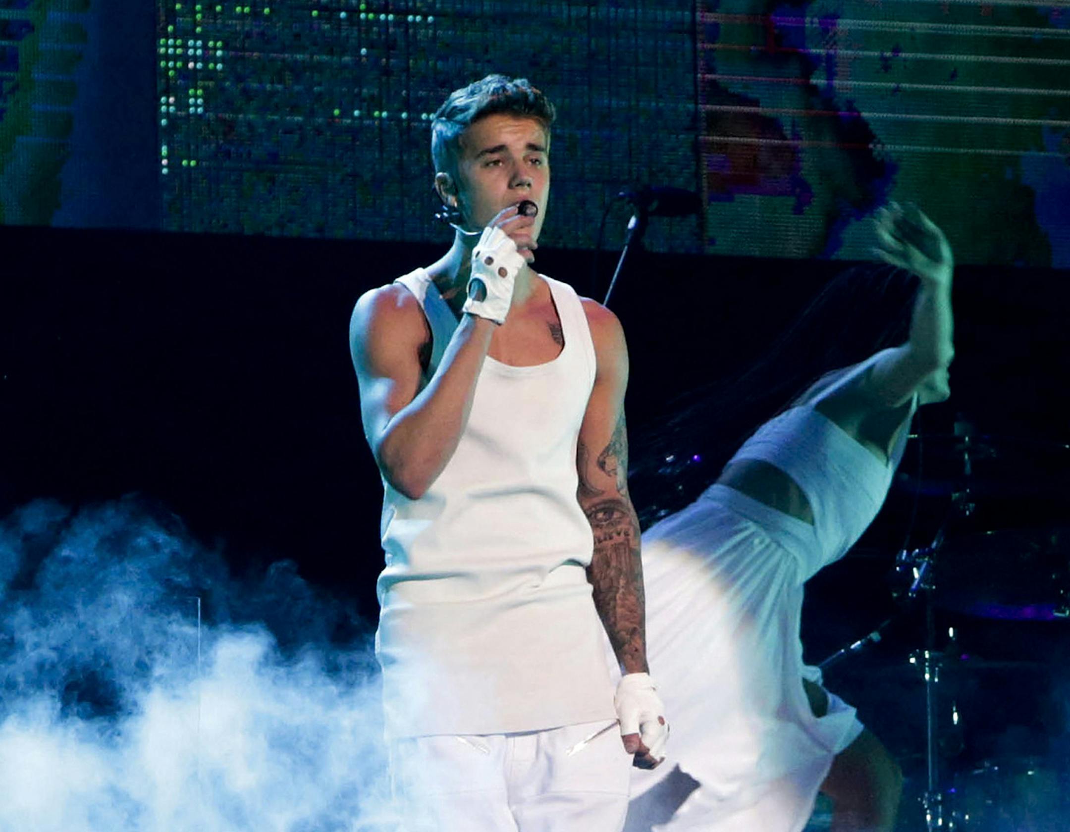 FILE - In this Sept. 29, 2013, file photo, Justin Bieber performs on a stage during his world tour concert in Beijing. Beijing said it won’t be inviting Justin Bieber to perform in China because of his past “bad behavior,” although it did concede that the Canadian singer has talent. In response to a question from a purported fan on its web page, the Beijing Municipal Bureau of Culture said it was acting in the interest of imposing standards and order and “cleaning up&