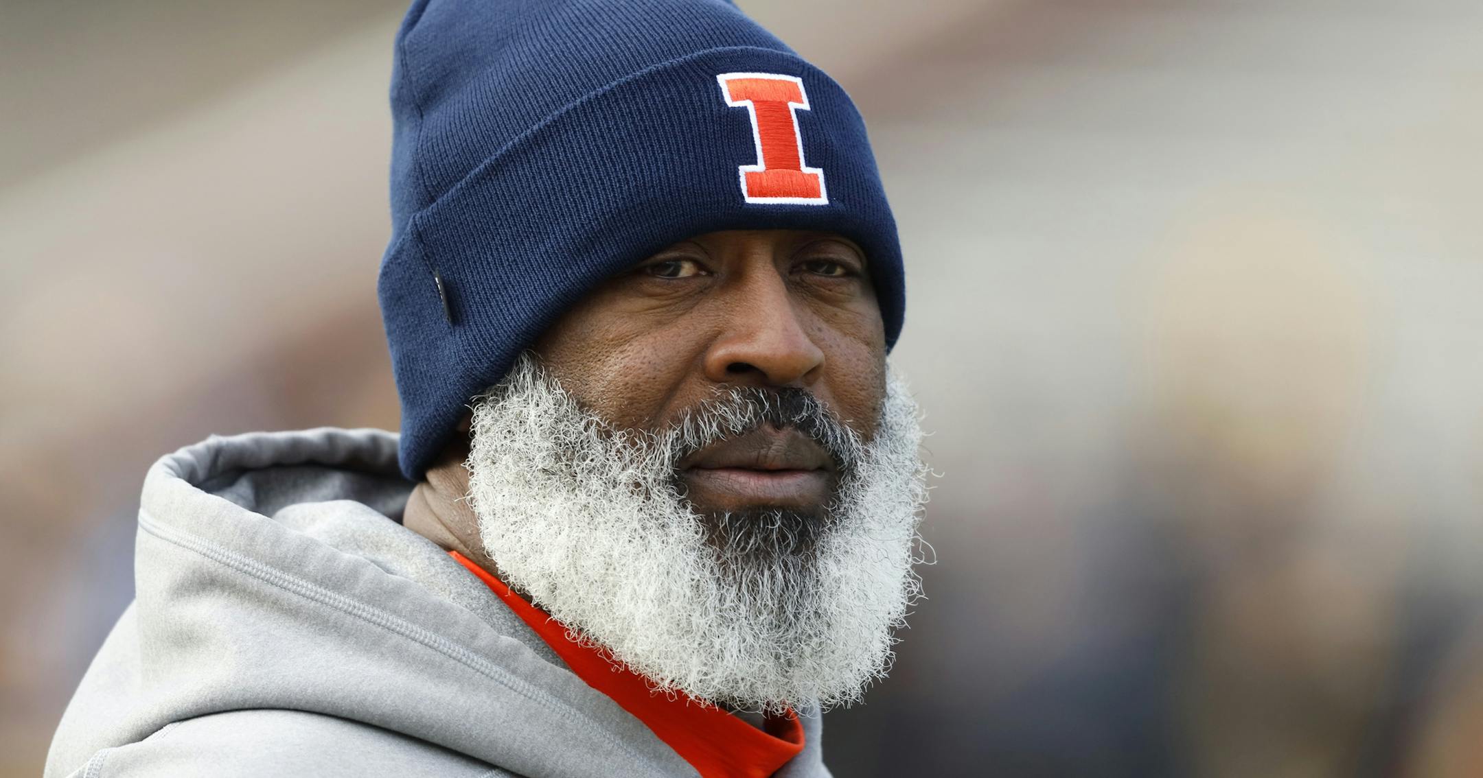 FILE - In this Nov. 23, 2019, file photo, Illinois head coach Lovie Smith walks on the field before an NCAA college football game against Iowa, in Iowa City, Iowa. Even after beating a Wisconsin team that was favored by 30 ½ points last year, Illinois heads into Madison as a 19 ½-point underdog as the two West Division rivals prepare to open the pandemic-delayed Big Ten season Friday night. (AP Photo/Charlie Neibergall, File)