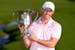Rory McIlroy, of Northern Ireland, holds the trophy after winning the Wells Fargo Championship golf tournament at the Quail Hollow Club Sunday, May 12
