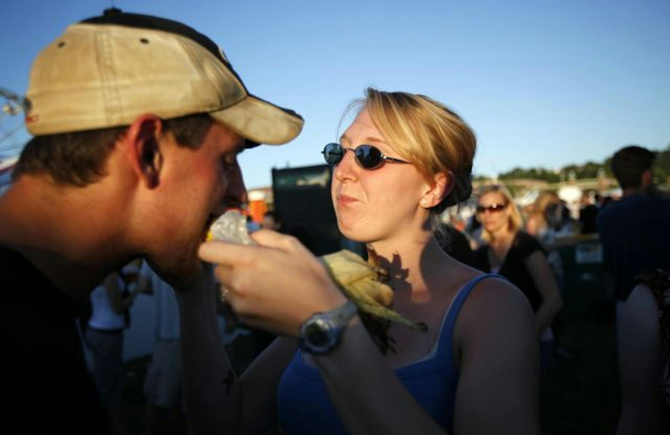 Caitlin Weber of Lakeville feeds a piece of corn to her boyfriend Patrick Weidenfeller at the 2009 Taste of Minnesota Thursday evening on Harriet Island in St. Paul.