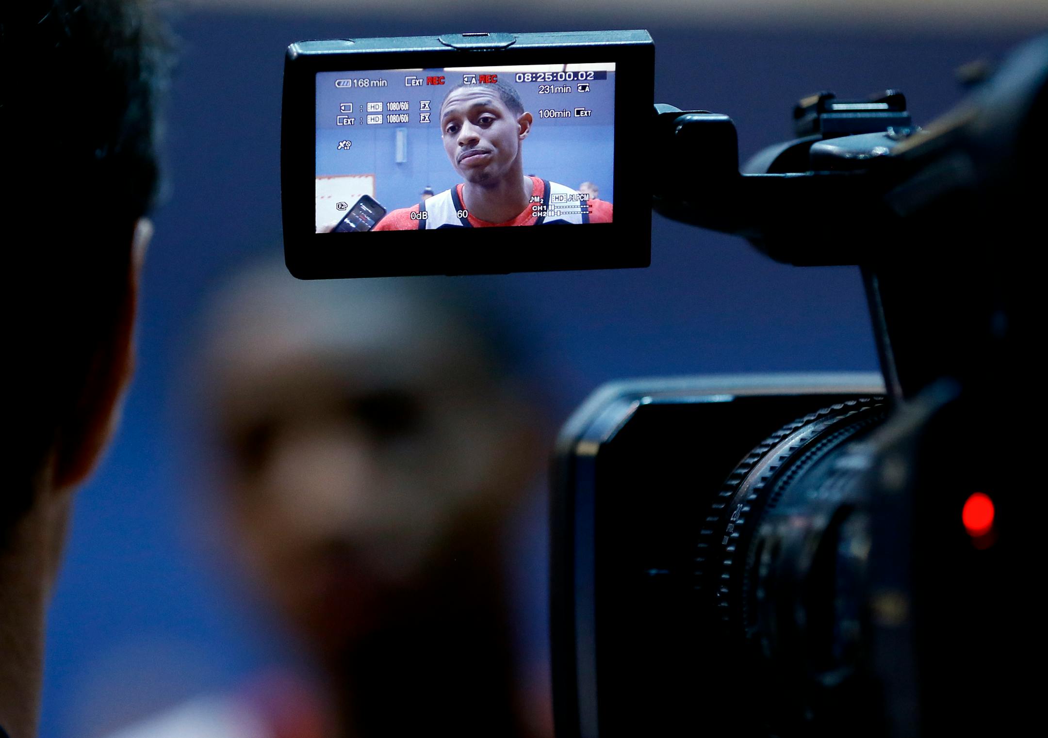 Brandon Knight is seen through a video camera view finder as he speaks to the media during a Milwaukee Bucks media availability session in London, Tuesday, Jan. 13, 2015. Milwaukee Bucks will play New York Knicks in an NBA game at the O2 Arena in London on Thursday. (AP Photo/Kirsty Wigglesworth)