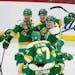 The Wild's Matt Boldy (12) celebrates with teammates after scoring a goal to win 4-3 in overtime against the Nashville Predators on Sunday at Xcel Ene