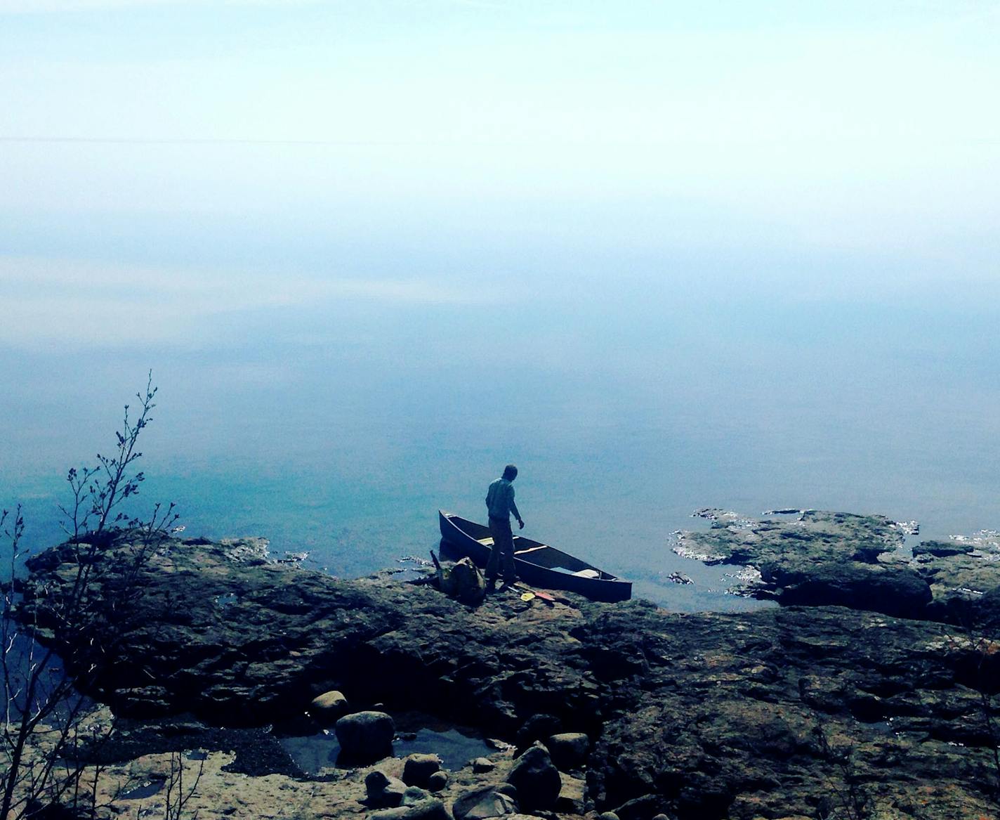 Split Rock State Park, Lake Superior
What equipment did you use&#xf3;a phone or a particular camera? i-phone
How did you get this shot? Did you employ any particular technique: did you get low or high to change the angle, or wait just for the right moment? I had just run back to our campsite to do a final sweep as my friend was loading the canoe. The lake was unusually calm, and when I turned I struck by the way the water seamlessly spilled into the sky. Our vessel looked so small against the bl