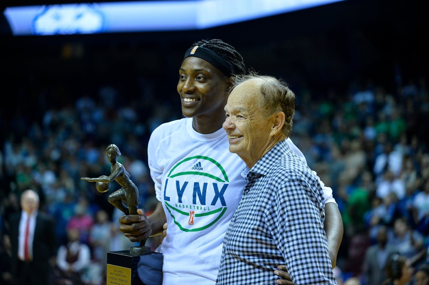 Minnesota Lynx center Sylvia Fowles (34) held her MVP trophy beside Lynx owner Glen Taylor Thursday night.