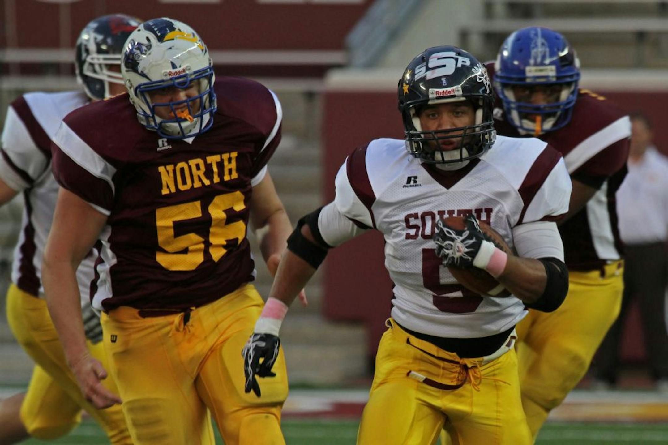 38th Annual Minnesota High School All-Star Football Game at TCF Bank Stadium. (left to right) North's Brandon Anderson of Sartell gave chase as South's Josh Vaughan of Bloomington Kennedy ran for a 49 yard gain. South would later score on the drive.