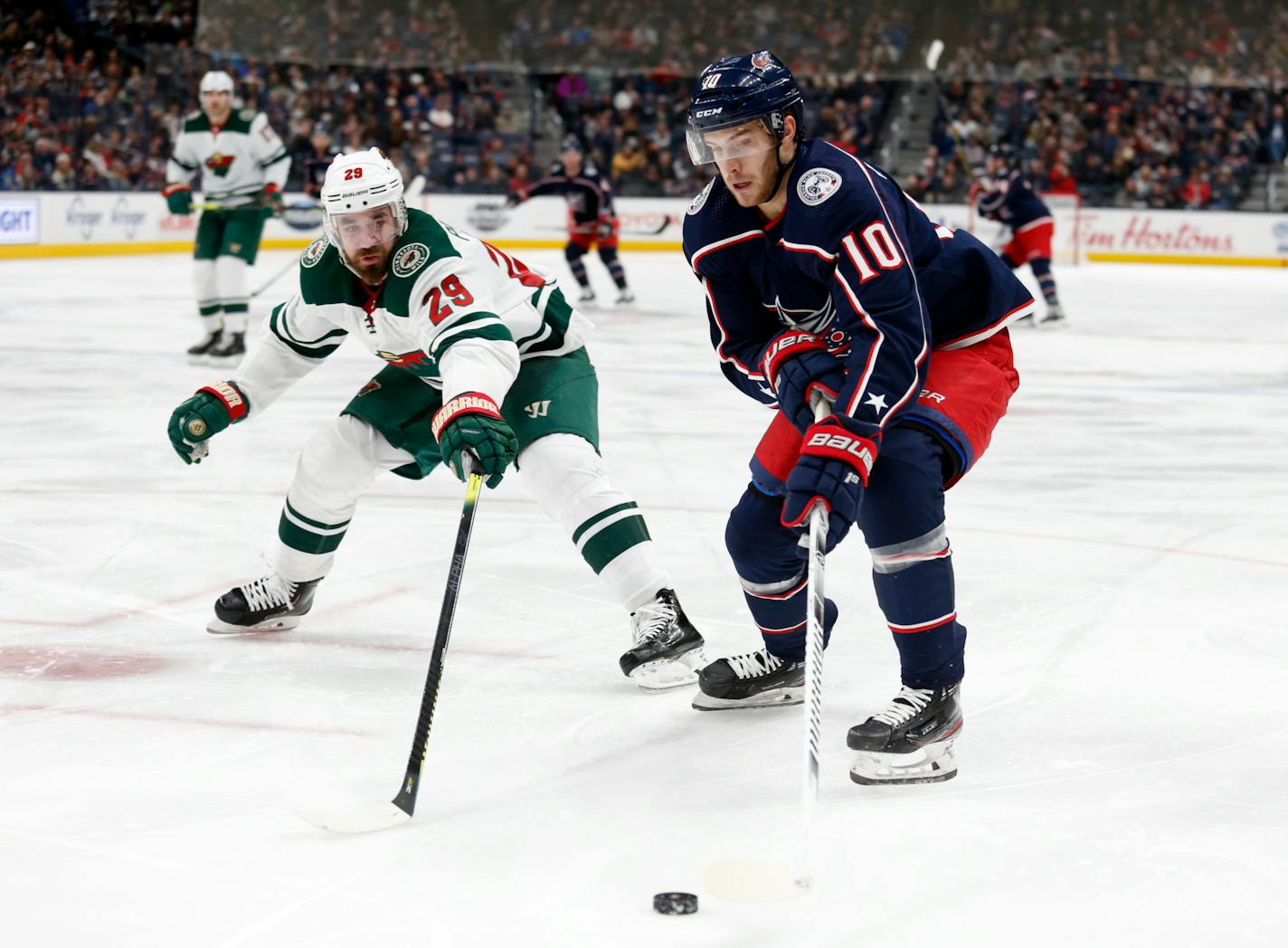 Columbus forward Alexander Wennberg controls the puck in front of Wild defenseman Greg Pateryn