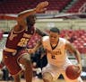 Minnesota University guard Nate Mason, right, dribbles against Temple guard Quenton DeCosey during the college basketball tournament, Puerto Rico Tip-