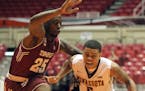 Minnesota University guard Nate Mason, right, dribbles against Temple guard Quenton DeCosey during the college basketball tournament, Puerto Rico Tip-