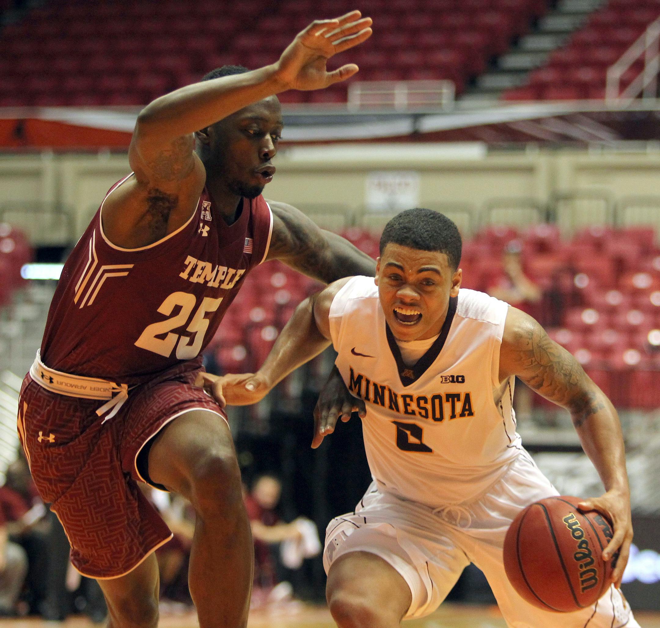Minnesota University guard Nate Mason, right, dribbles against Temple guard Quenton DeCosey during the college basketball tournament, Puerto Rico Tip-Off, in San Juan, Thursday, Nov. 19, 2015. (AP Photo/Ricardo Arduengo)