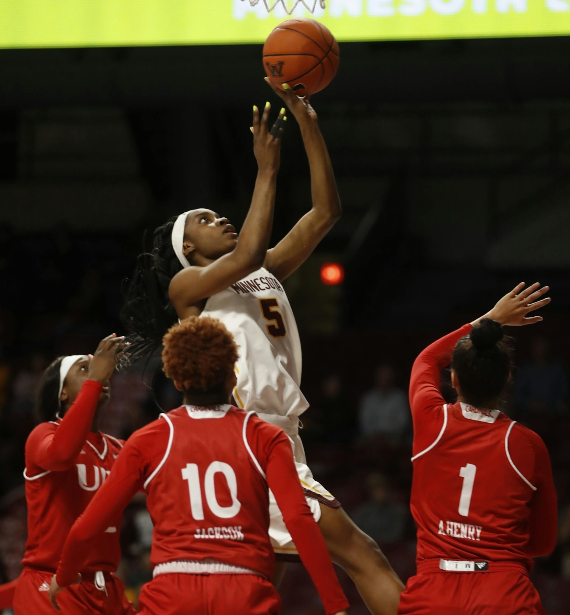Taiye Bello(5) floats a ball above Incarnate Word defense for 2 points.
