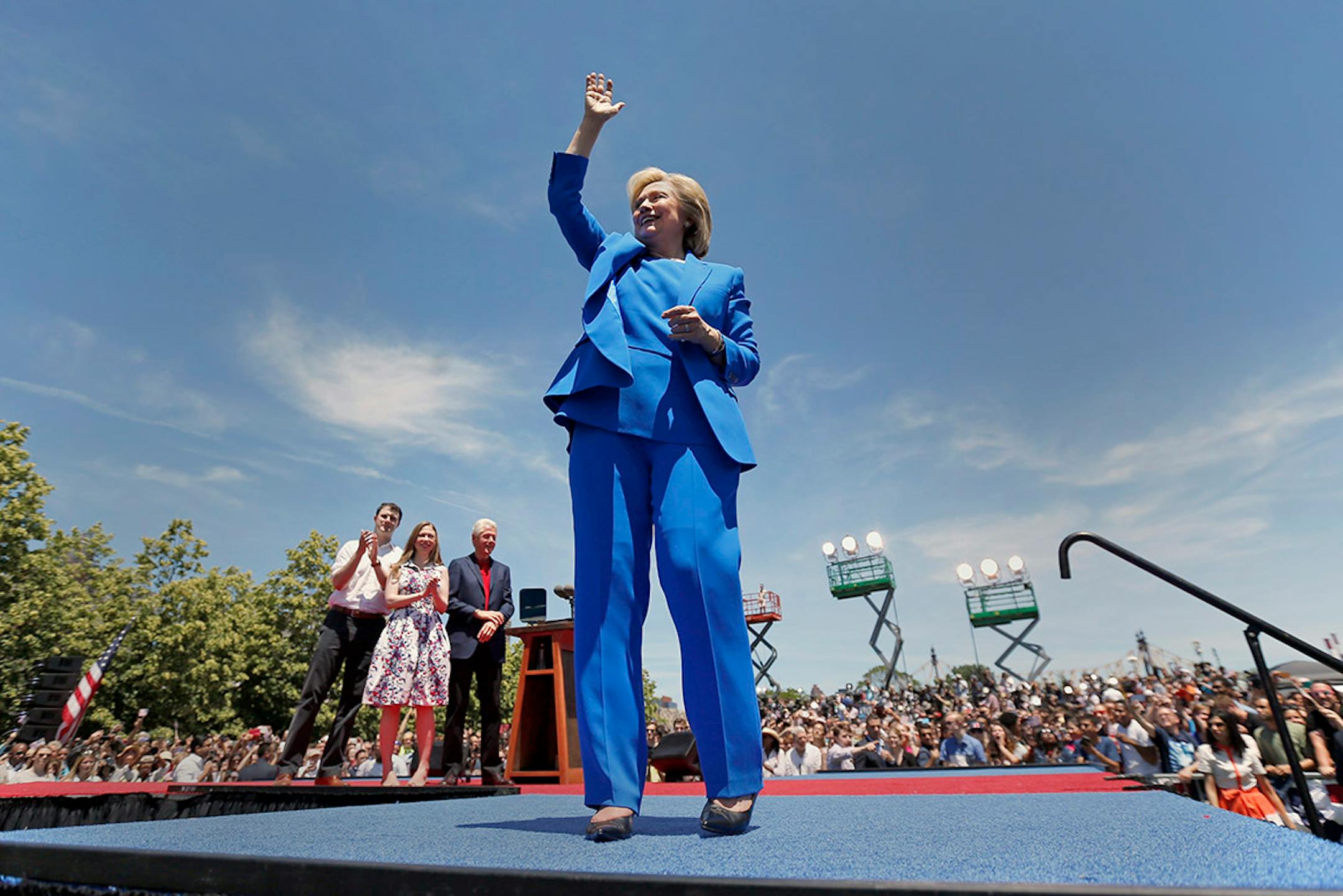 Democratic presidential candidate, former Secretary of State Hillary Rodham Clinton, right, acknowledges supporters as her husband, former President Bill Clinton, center right, their daughter Chelsea Clinton, center left, and her husband Marc Mezvinsky watch after a speech Saturday, June 13, 2015, on Roosevelt Island in New York.