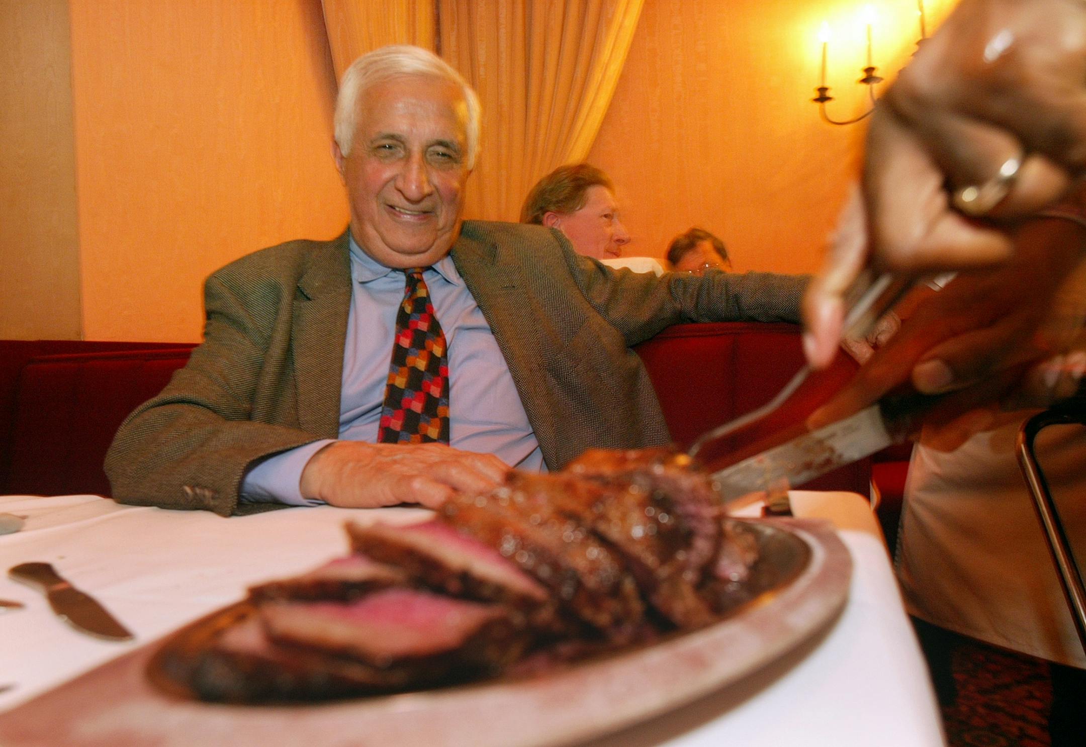 Sid Hartman, right, is served a "Silver Butter Knife" steak by Frank Adams at Murray's, Minneapolis, Mn. The Booth Sid is sitting in his booth.