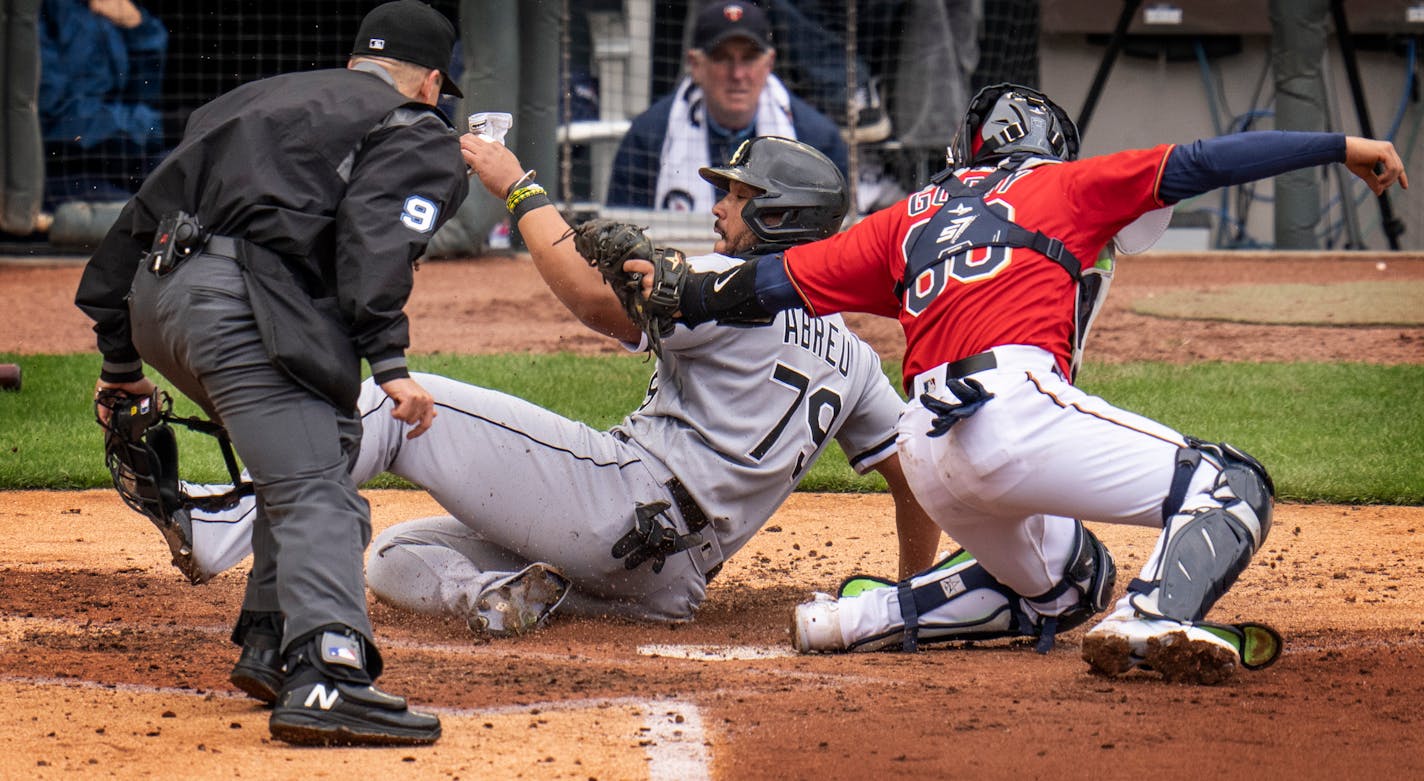 Chicago White Sox DH Jose Abreu ,(79) was tagged out by Minnesota Twins catcher Jose Godoy ,(60) third inning in Minneapolis, Minn., on Sunday, April 24, 2022.