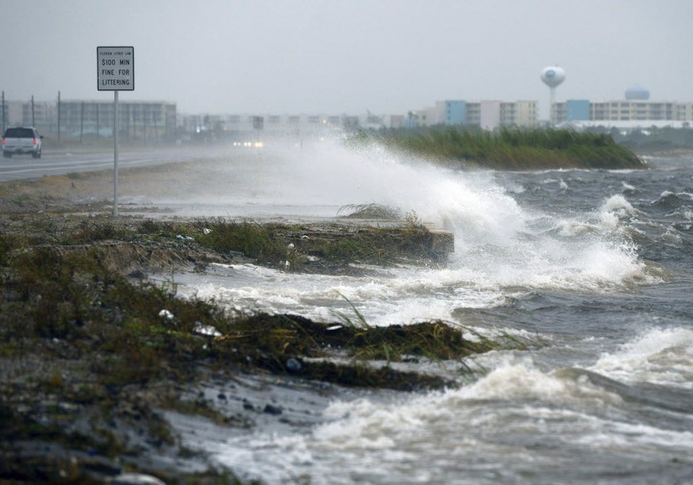 Waves from the Choctawhatchee Bay pound the seawall on Okaloosa Island in Fort Walton Beach, Fla.,Wednesday.