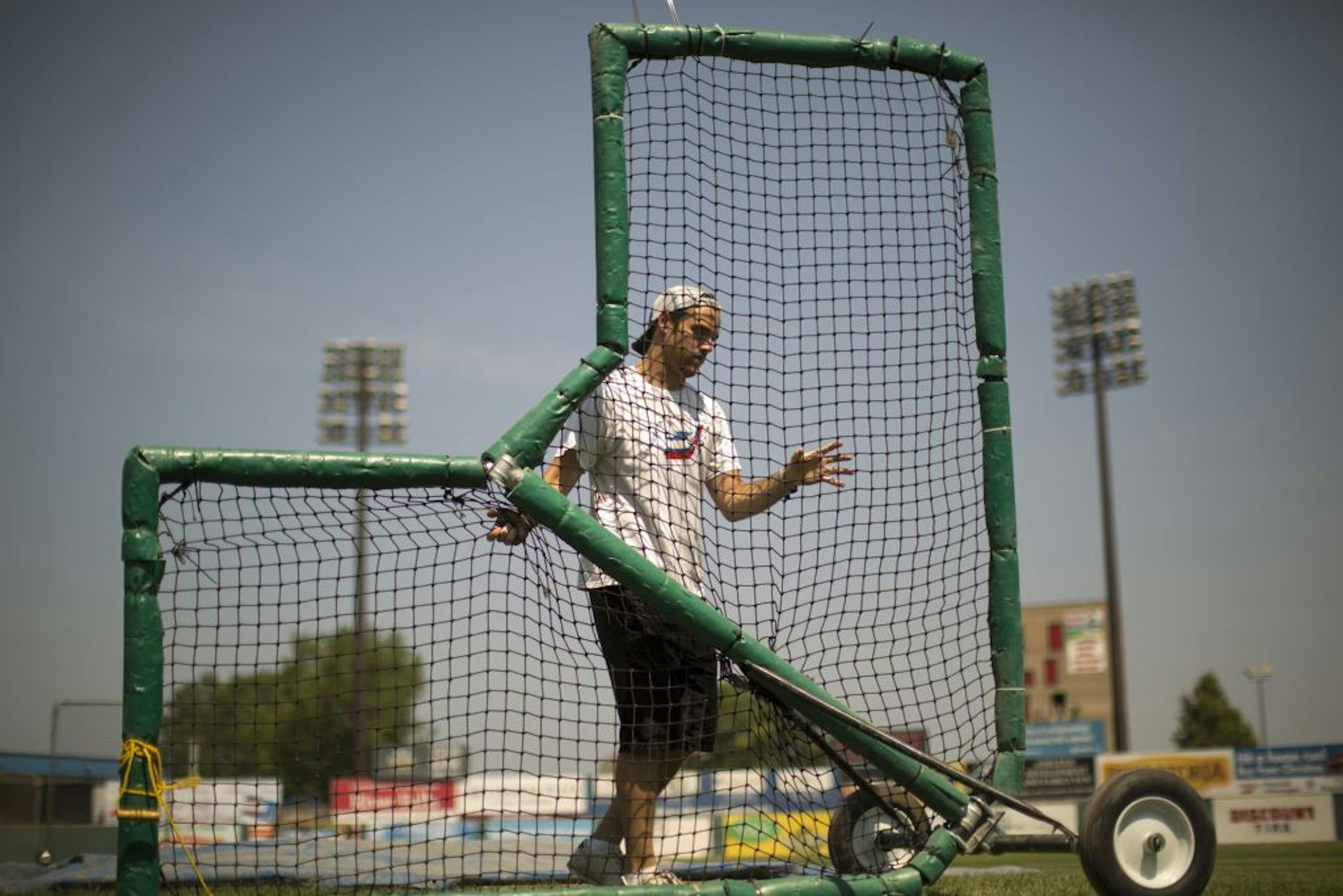 Gage Miller wheeled a screen to the pitcher's mound for batting practice. "We're ready to roll" on a new park, City Council President Kathy Lantry said.