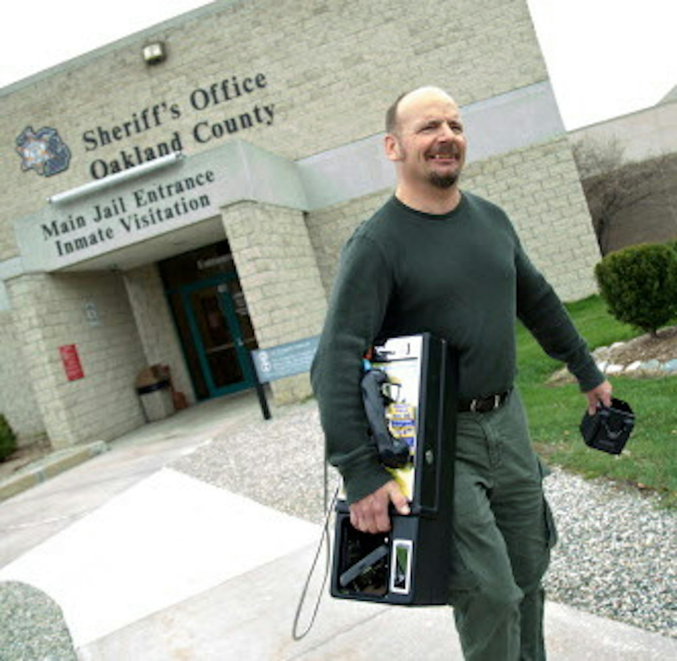 Greg Andrick, 49, of West Bloomfield, Mich., carries a pay telephone to his car after removing it from the Oakland County Jail on April 21, 2015, in Pontiac, Mich. He is president of the Michigan Pay Telephone Association. (Salwan Georges/Detroit Free Press/TNS) ORG XMIT: 1171451