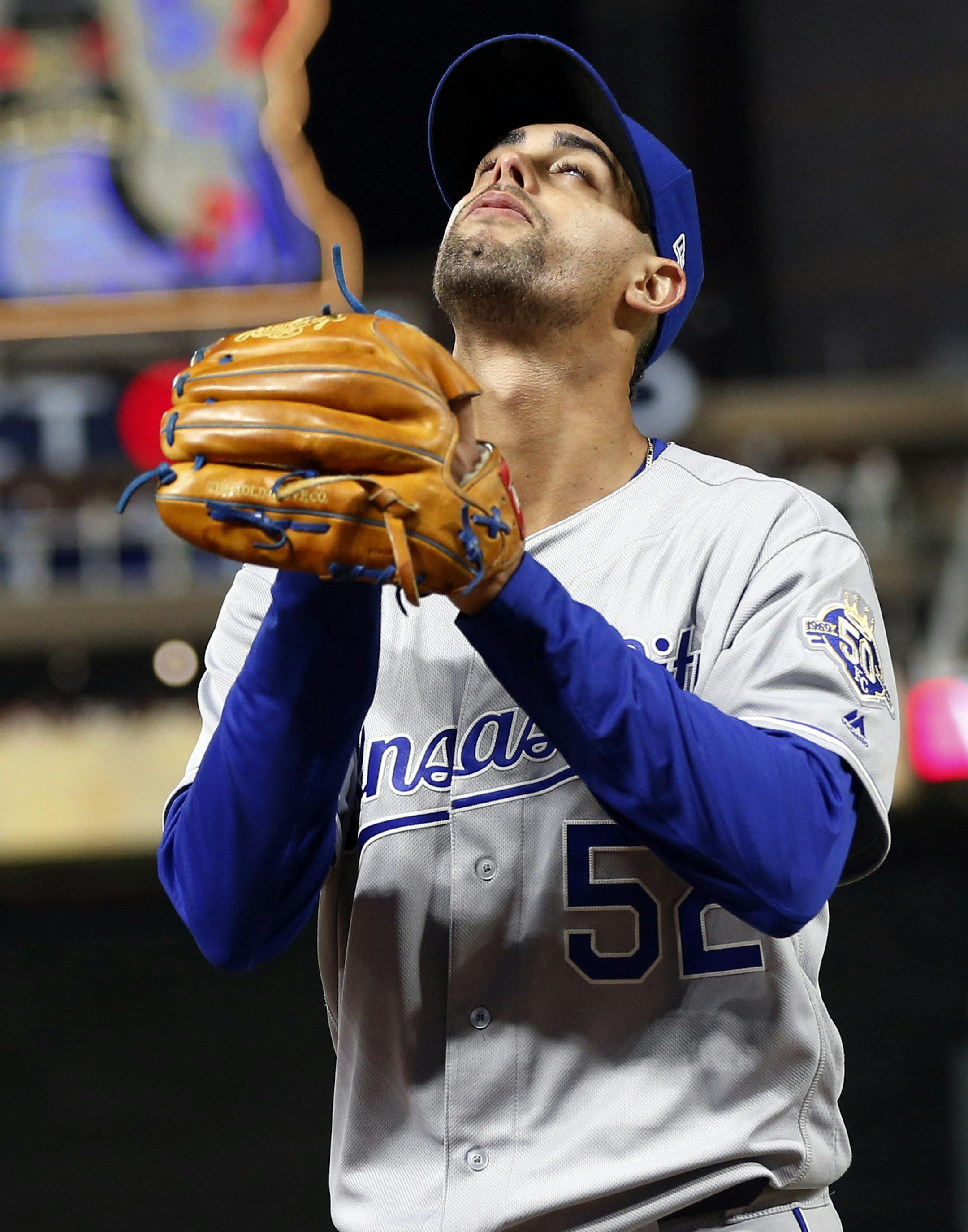 Kansas City Royals pitcher Jorge Lopez looks skyward as he heads to the dugout after being pulled after going into the ninth inning with a perfect game against the Minnesota Twins in a baseball game Saturday, Sept. 8, 2018, in Minneapolis. The Royals won 4-1. (AP Photo/Jim Mone)
