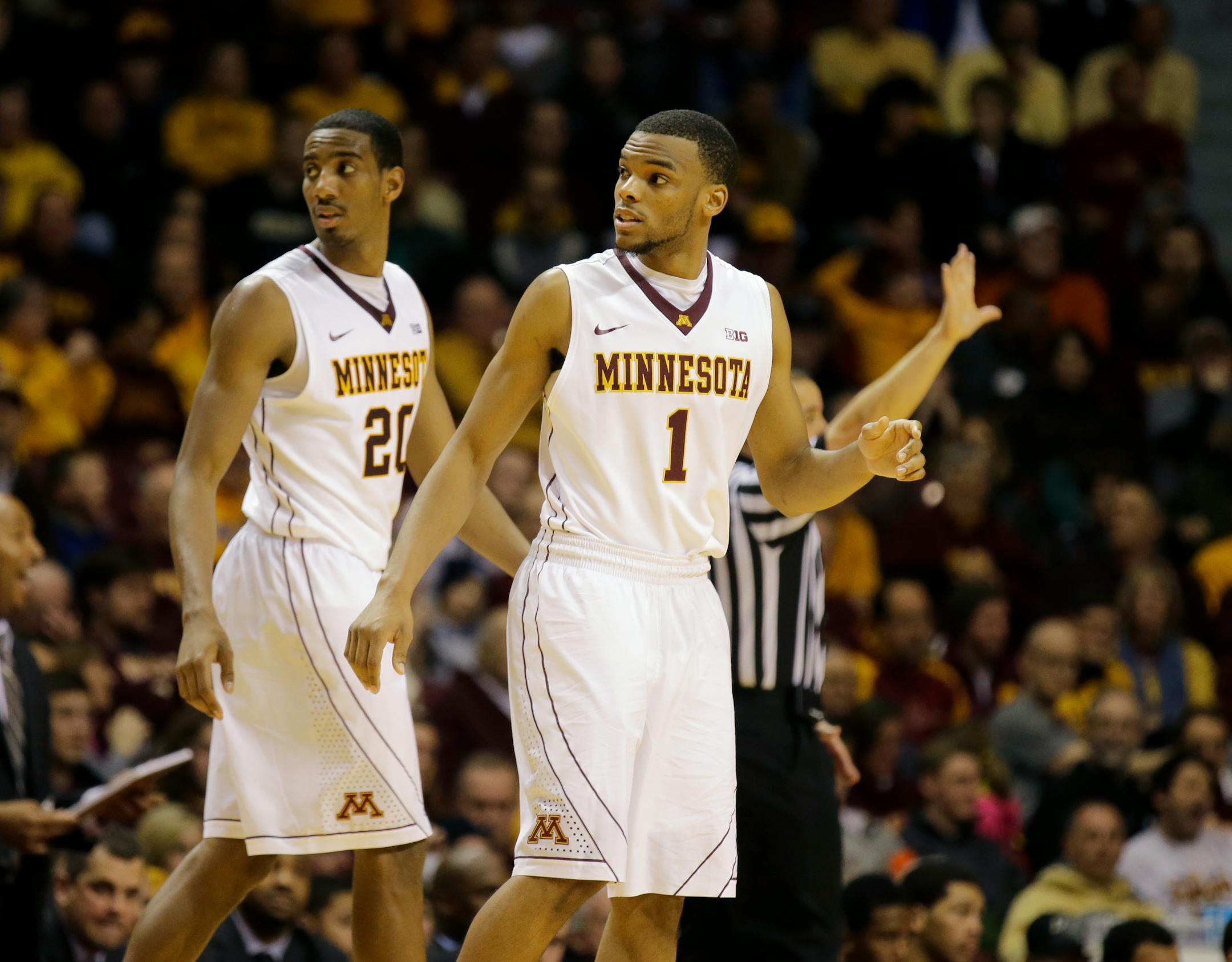 Minnesota guards Andre Hollins (1) and Austin Hollins (20) check back in during the second half of an NCAA college basketball game against Purdue in Minneapolis, Sunday, Jan. 5, 2014. Minnesota won 82-79. (AP Photo/Ann Heisenfelt)