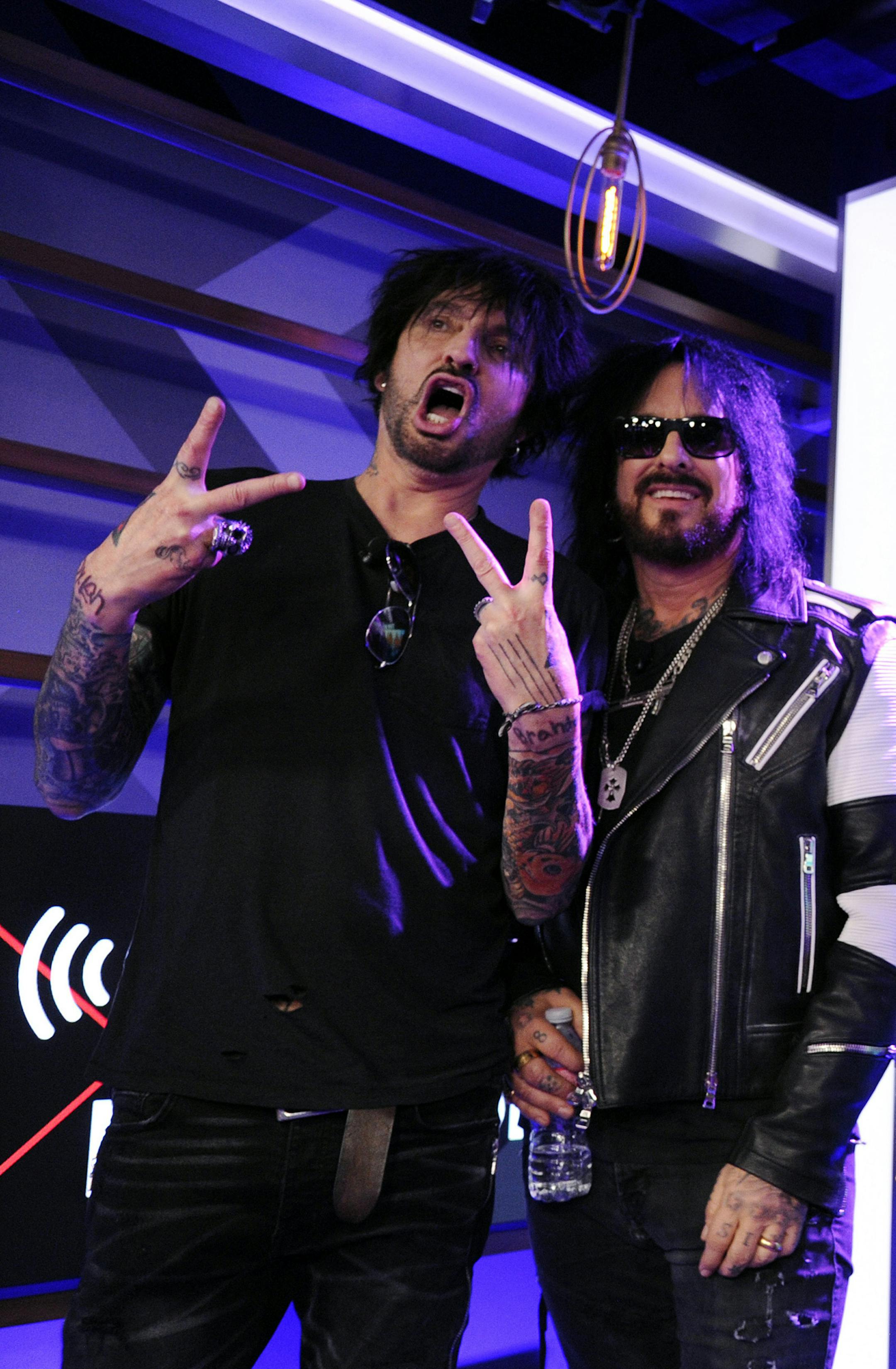 Tommy Lee, from left, Nikki Sixx, Vince Neil and Mick Mars of Motley Crue pose together during a news conference to announce The Stadium Tour 2020 featuring Motley Crue, Poison and Def Leppard, at the SiriusXM offices, Wednesday, Dec. 4, 2019, in Los Angeles. (AP Photo/Chris Pizzello)