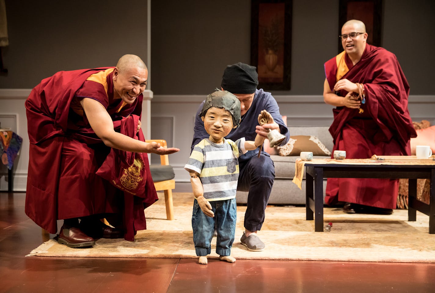 Tsering Dorjee Bawa, puppeteer Masanari Kawahara and Eric &#xec;Pogi&#xee; Sumangil in "The Oldest Boy" at the Jungle Theater.
PHOTO CREDIT: Dan Norman