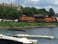A BNSF train goes through Wayzata in July 2015 near where some temporary docks were added to give boaters more places to stop in the town. Because the
