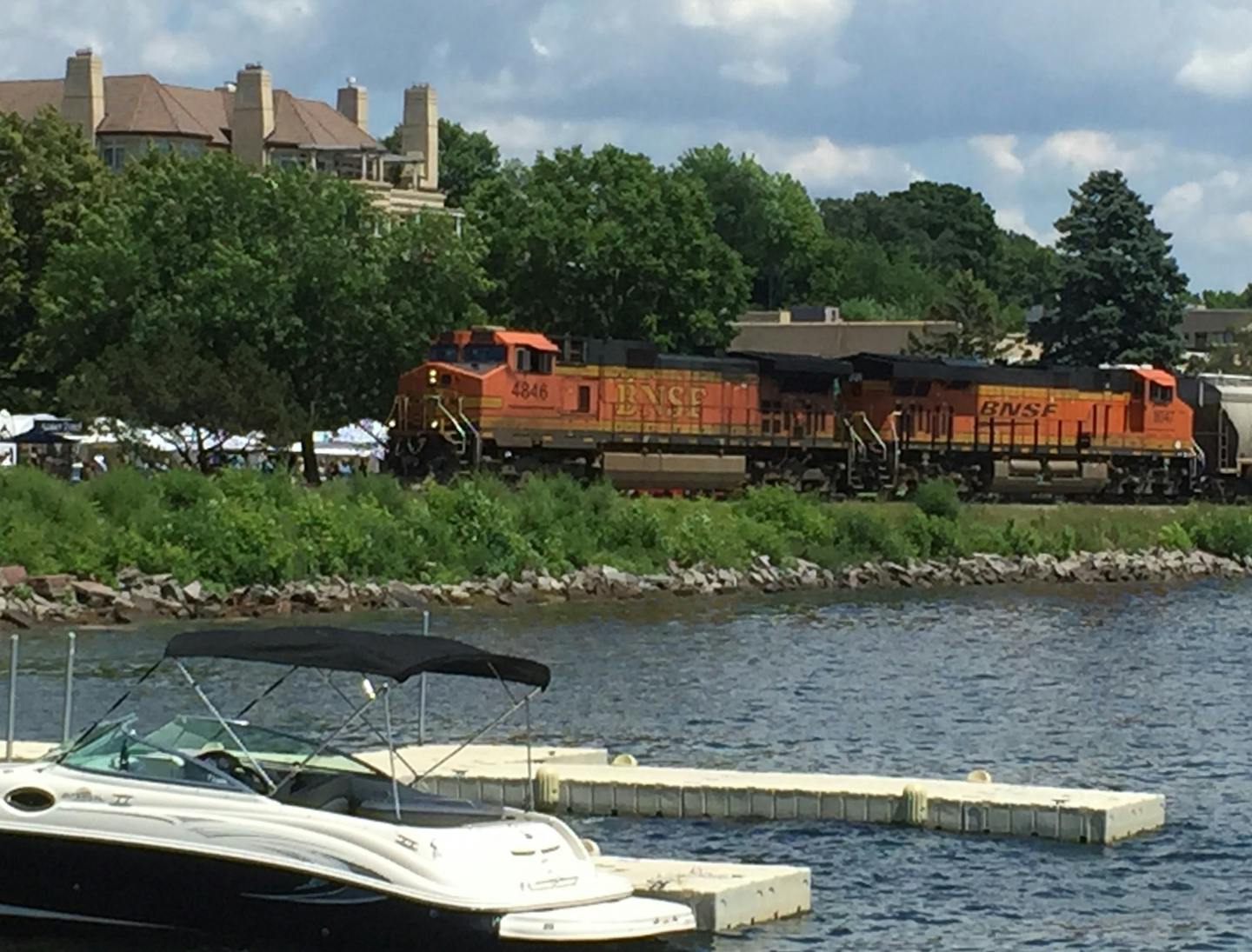 A BNSF train goes through Wayzata in July 2015 near where some temporary docks were added to give boaters more places to stop in the town. Because the city&#xed;s downtown is cut off from its lakefront by BNSF railroad tracks, the city is working to make the area more accessible and safer for boaters, bikers and other visitors as part of its Lake Effect lakefront improvement project.