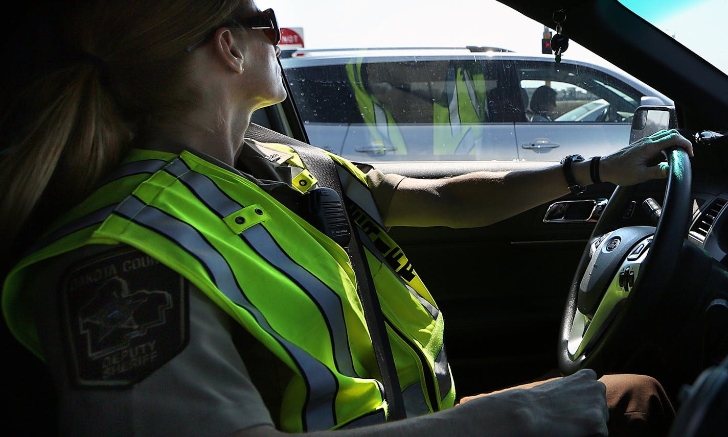 Dakota County deputy Jennifer Lenarz observed a driver as she texted on her cellphone while waiting for a traffic light to change Wednesday in Eagan. Lenarz issued a ticket.