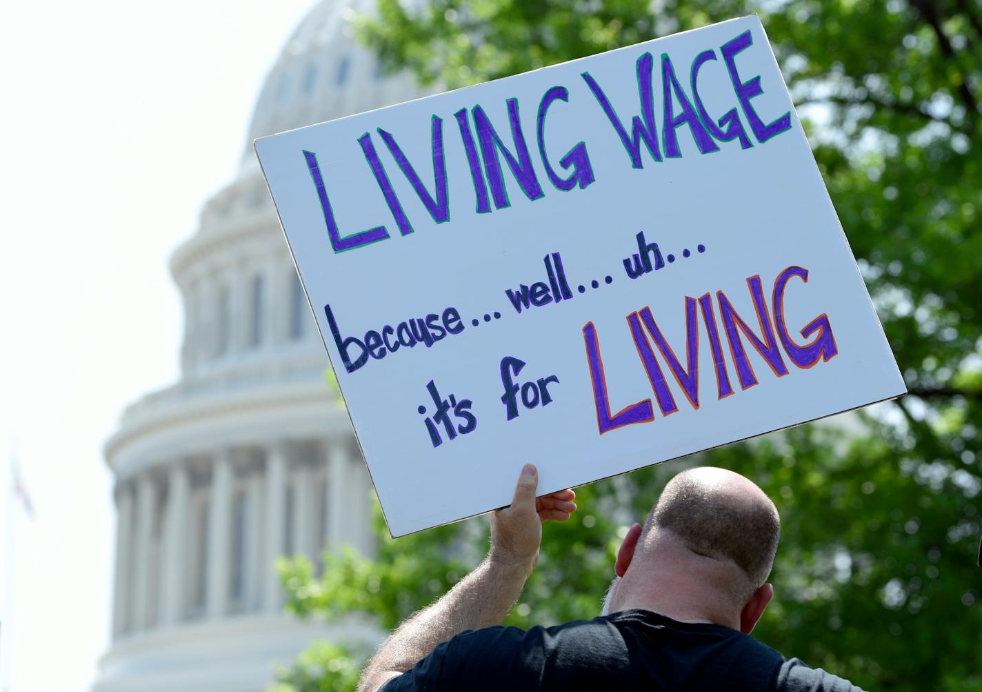 A person held up a sign during the "Poor People's Campaign: A National Call for Moral Revival" on Capitol Hill in Washington, Monday. Events in Minnesota were tied to this national campaign.