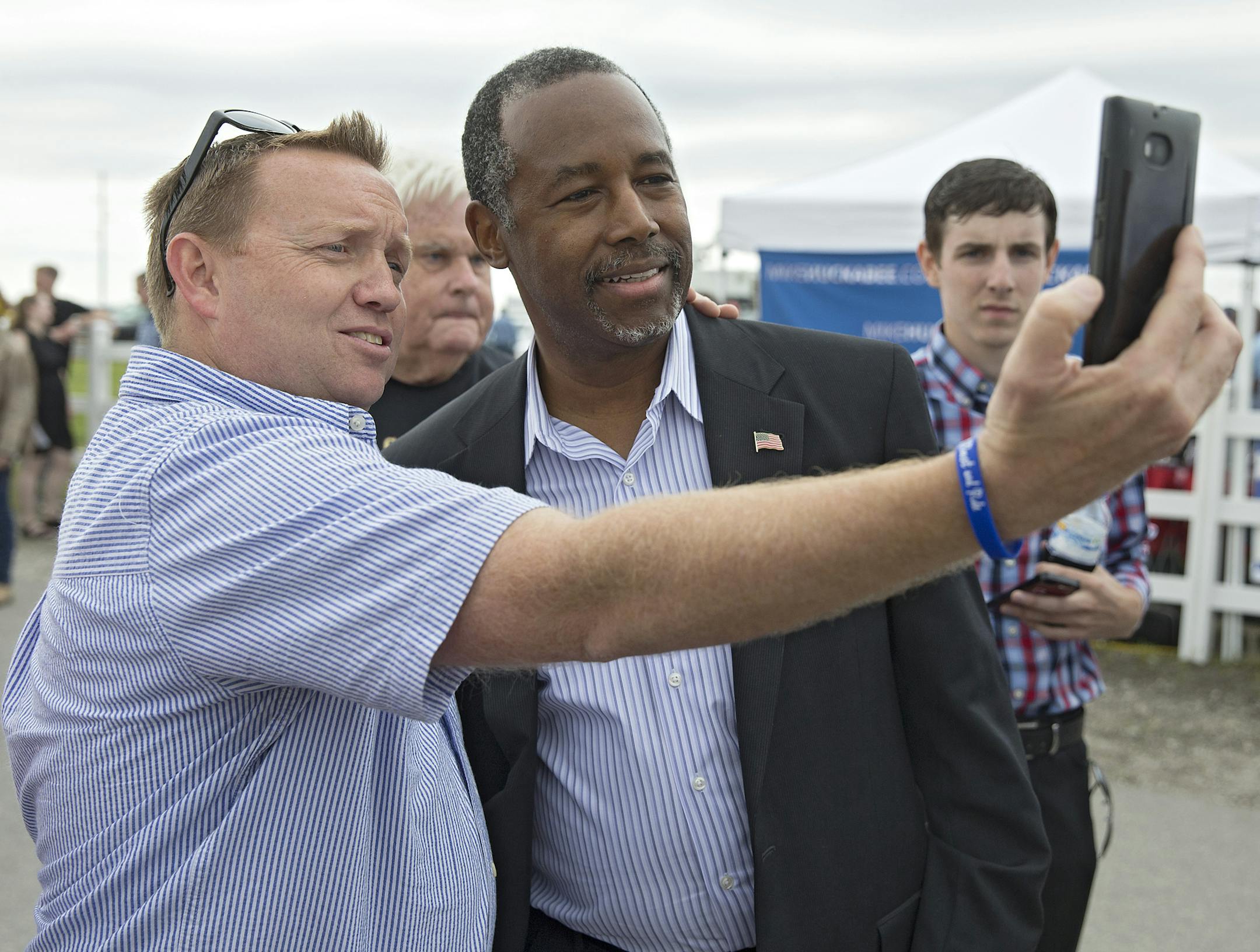 Ben Carson, right, attends "Joni’s Roast & Ride,” in Boone, Iowa, June 6, 2015. The daylong political fundraiser hosted by Sen. Joni Ernst (R-Iowa) drew seven declared or likely Republican presidential candidates, including Carson, a retired neurosurgeon. (Stephen Mally/The New York Times)